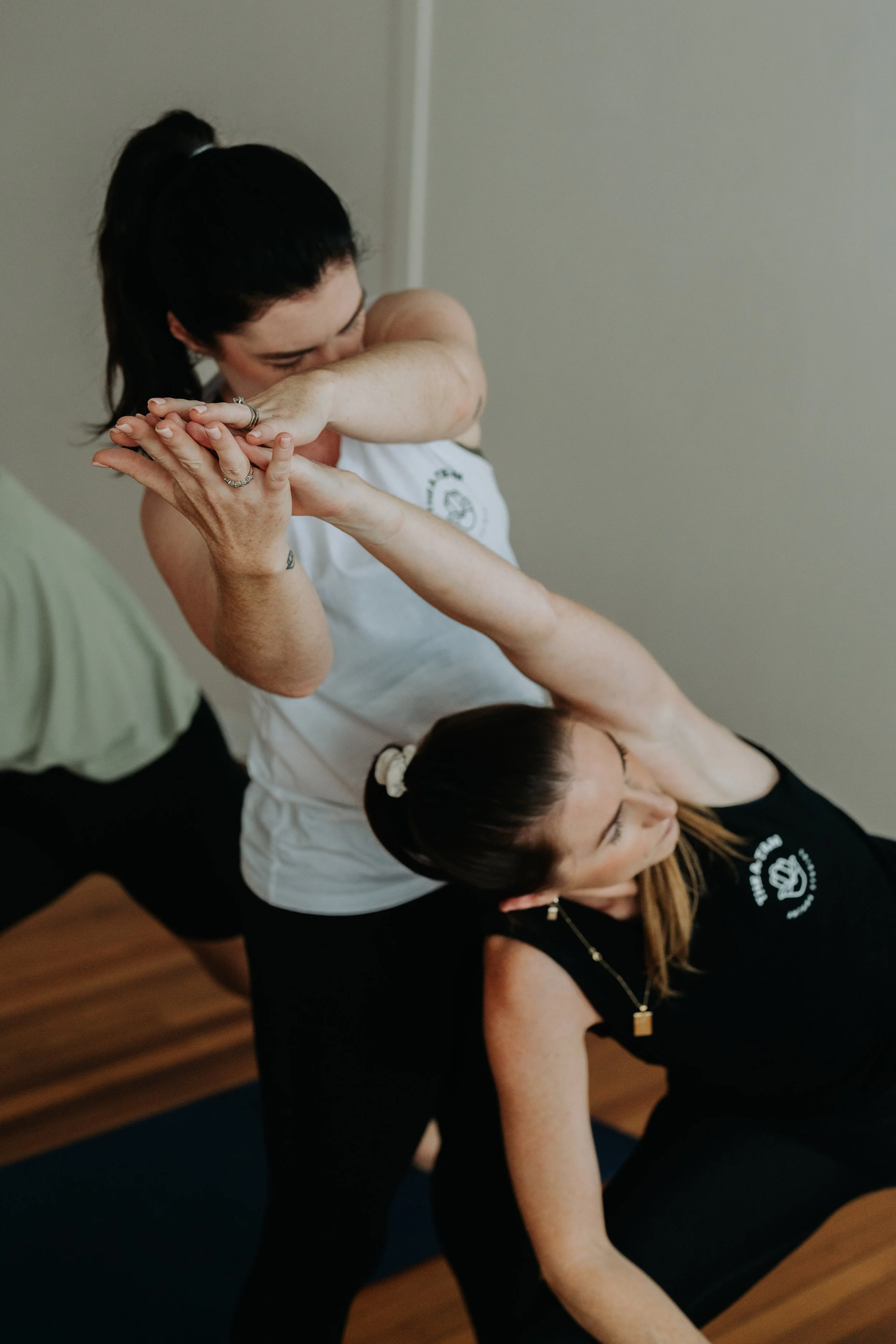 Amy Pattison gently guiding the body of a mentee during a one-on-one training session