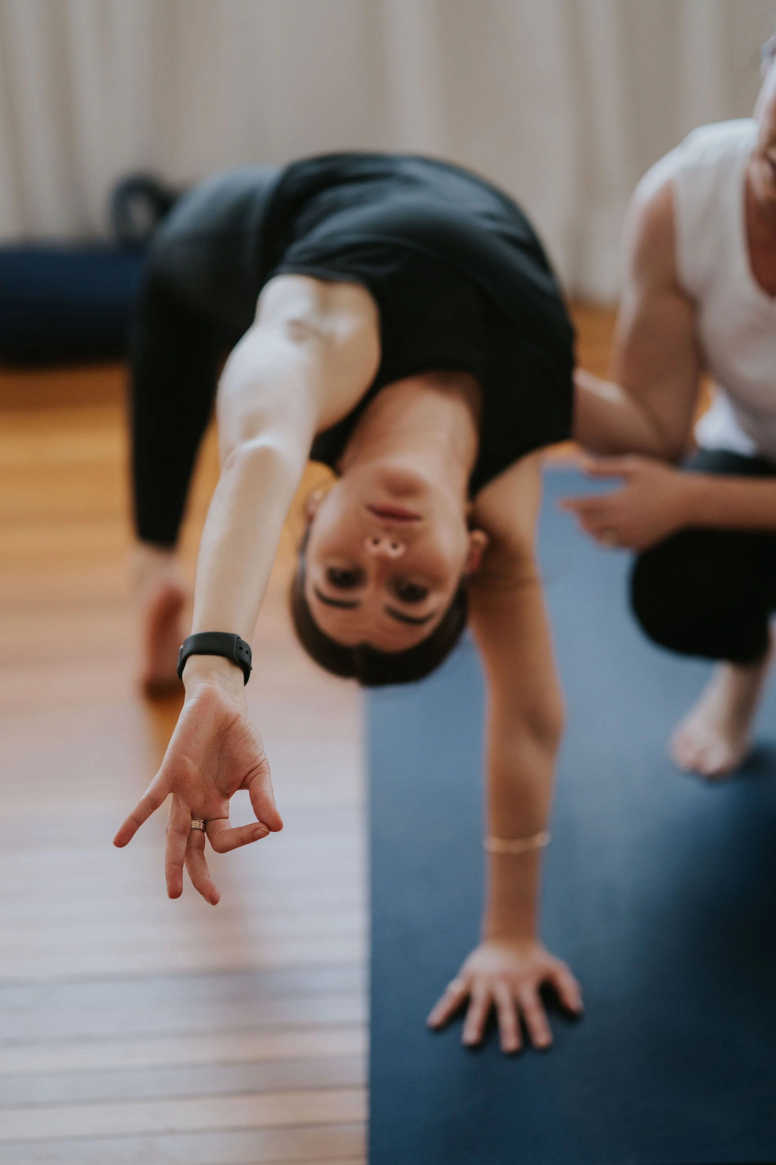 Amy gently guiding the body position of a mentoring student during a one-on-one session