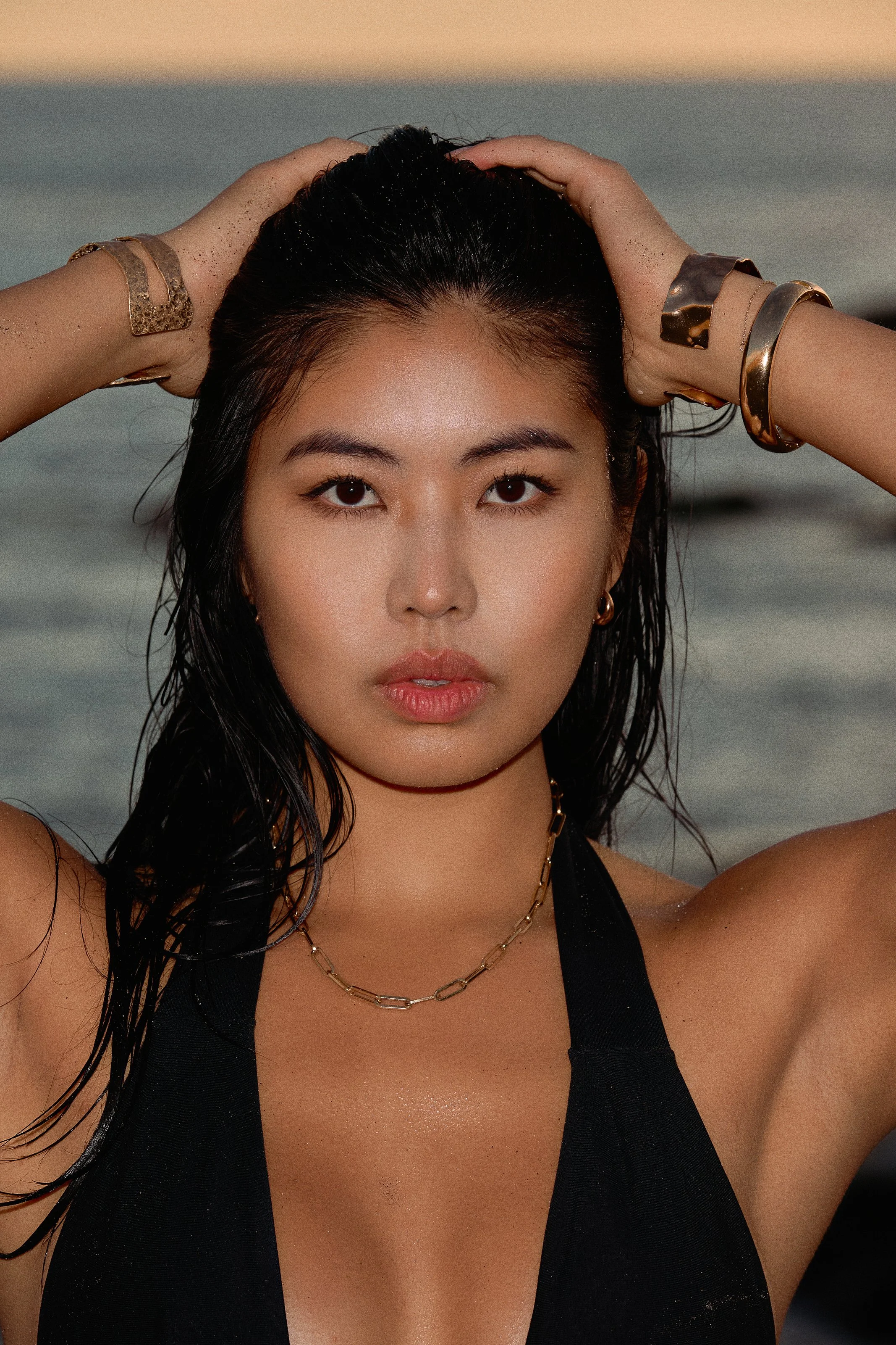 Swimwear photography in Los Angeles: black swimsuit portrait with wet hair at golden hour, by Moises Martinez