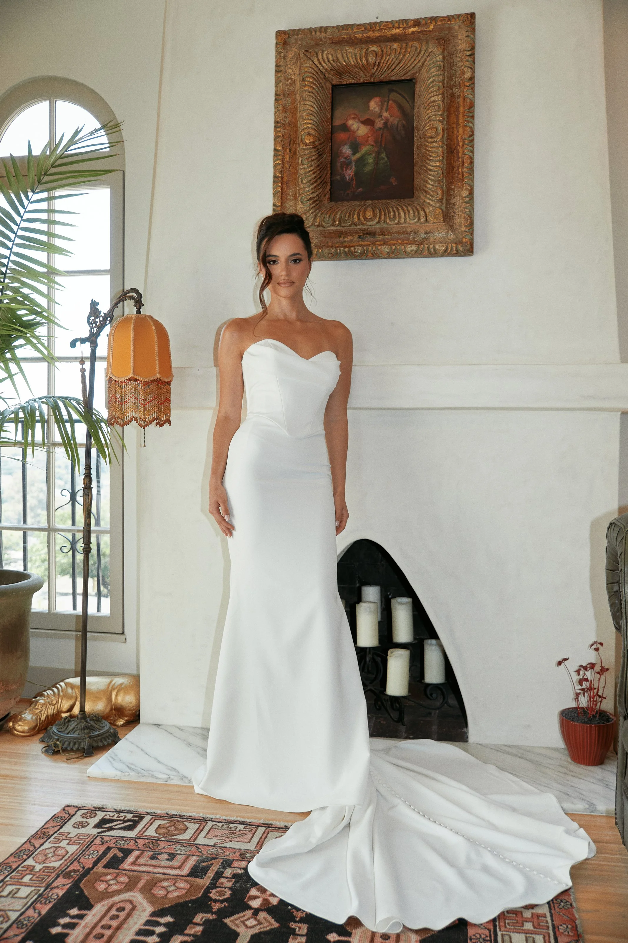 Fashion photography in Los Angeles: white strapless bridal gown in a sunlit interior, by Moises Martinez