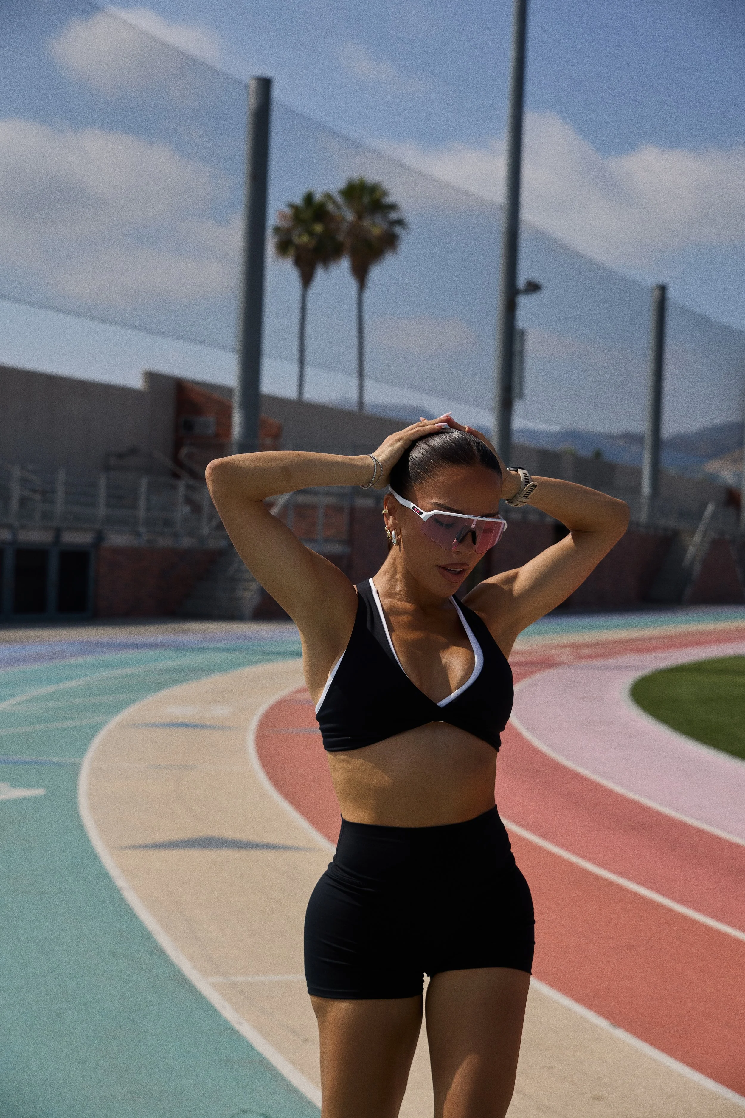 Athleisure campaign image shot in Los Angeles featuring fitness model on outdoor track with natural light