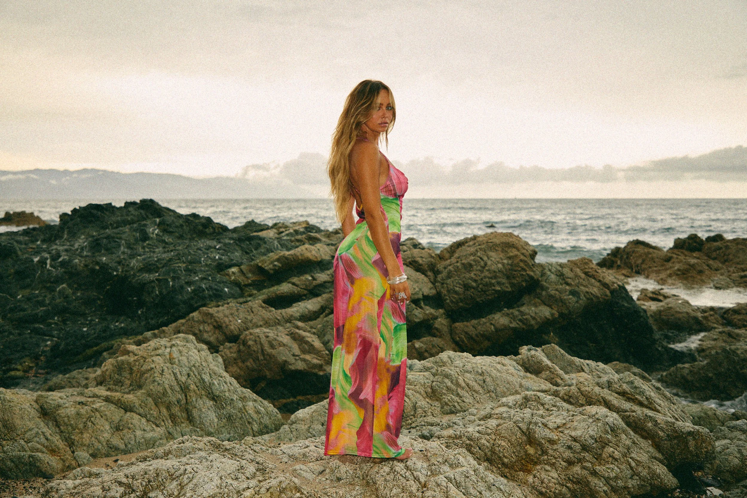 Lifestyle fashion campaign image shot in Los Angeles featuring model on beach with natural light and flowing dress
