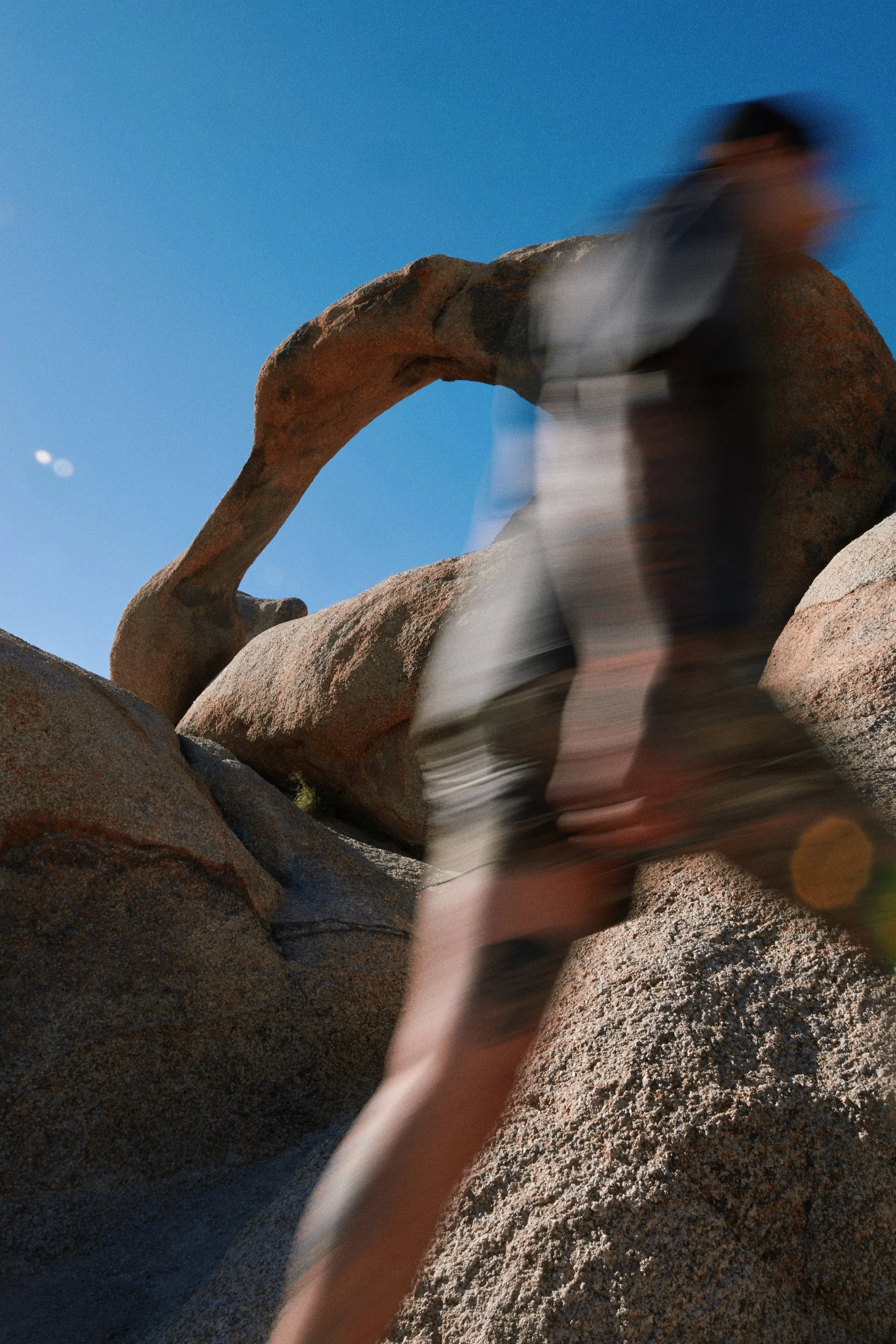 Activewear photography in Los Angeles: motion blur, climbing desert boulders in camo shorts, by Moises Martinez