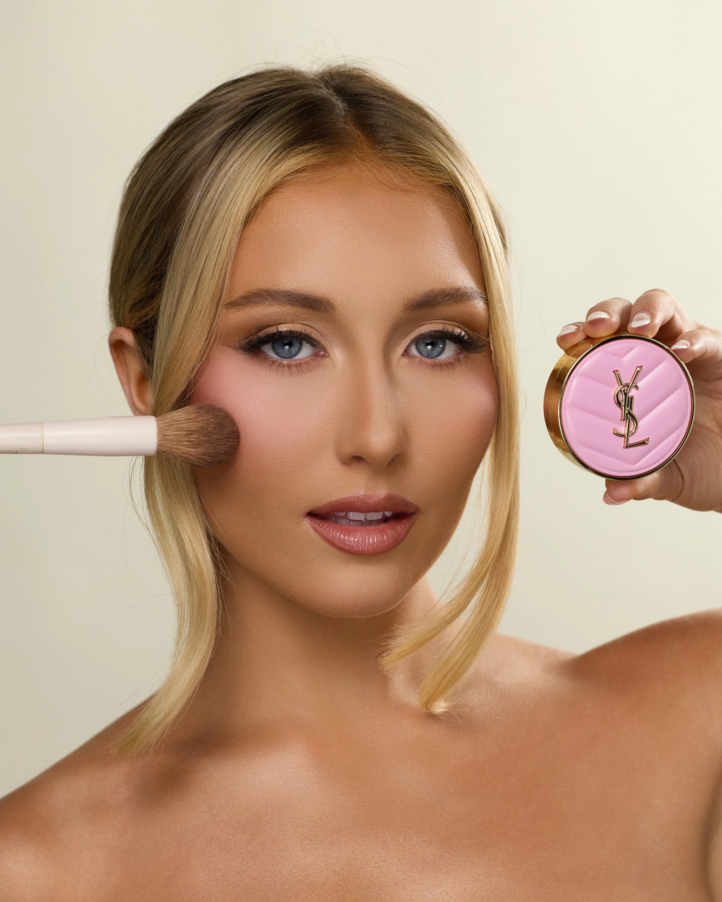 Beauty photography in Los Angeles: blush brush and pink compact held to the face, by Moises Martinez