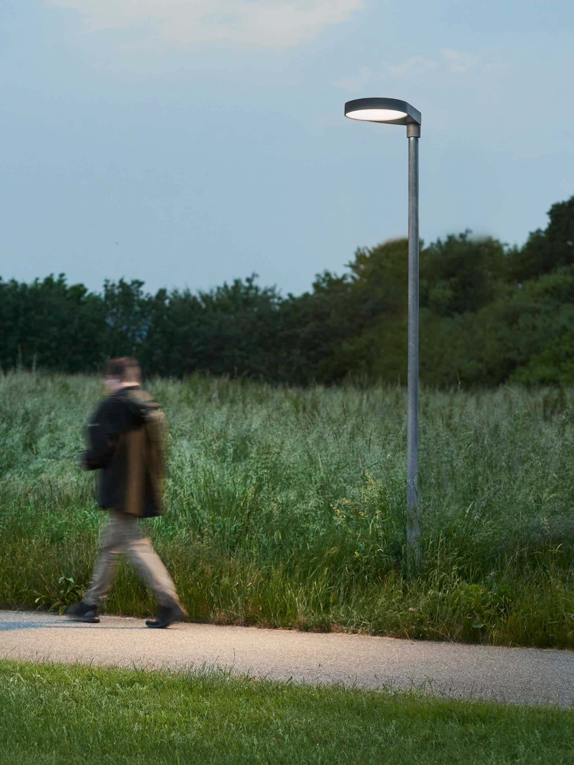 Otto L1700 post light with a person walking by – outdoor use