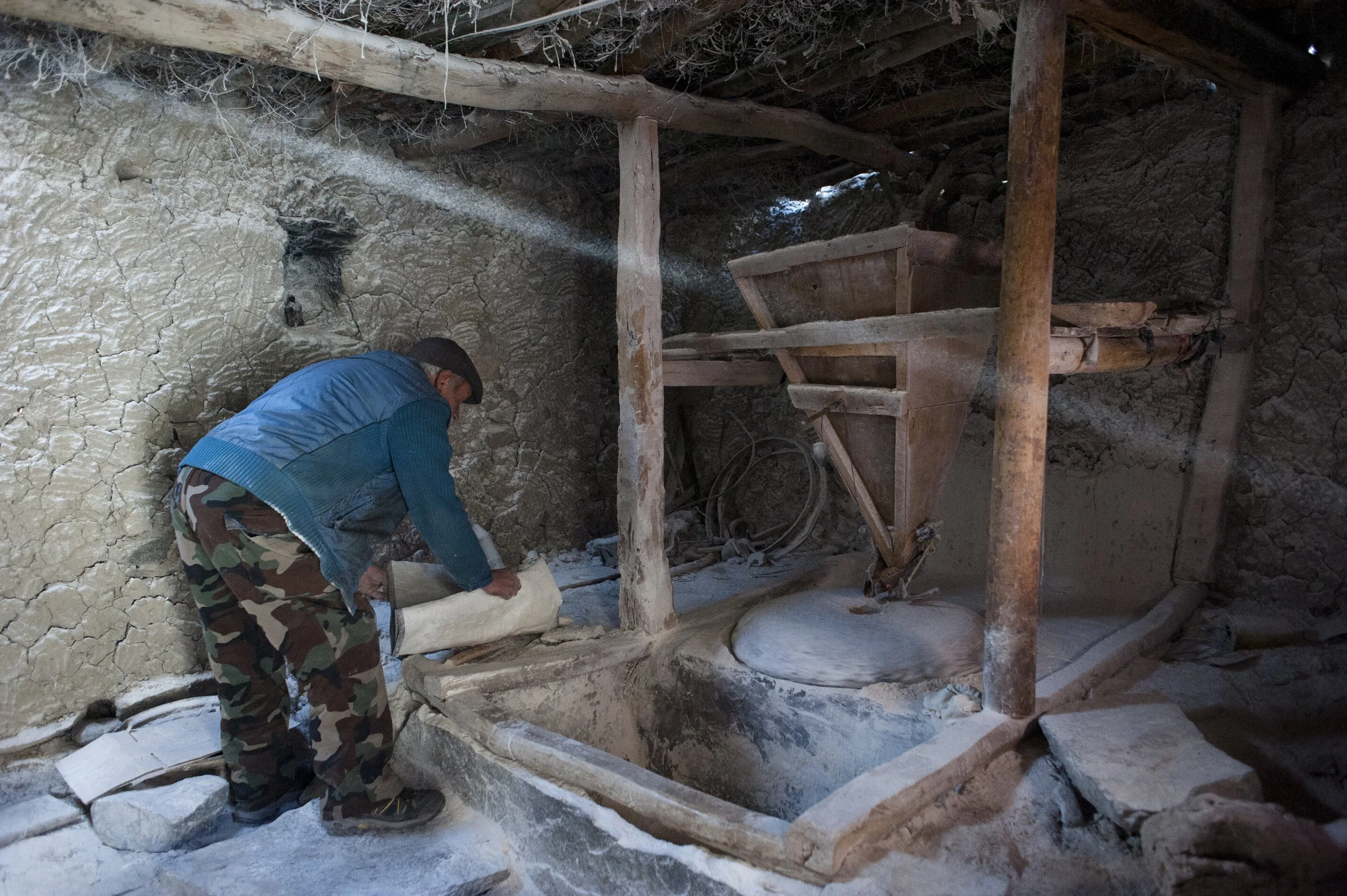 Sarabdek grinds flour in the water mill. Villagers make flour by themselves. There are 10 water mills in the village. At each house, bread tastes different as everyone bakes it in their own way, some add some oil, others more salt. The price of a bag