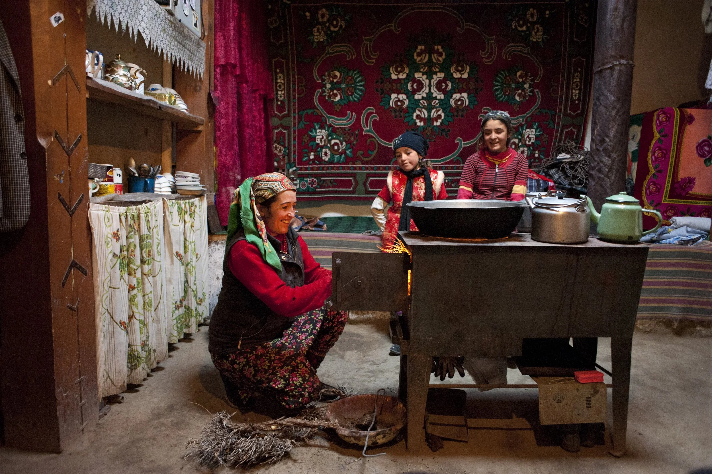 Firuza Gulguna’s mum lights a stove to prepare dinner in the summer room. Pamiri houses are divided into two parts: summer and winter. The summer room stays cool during hot days, but as soon as first cold comes, the family moves to a smaller room whi