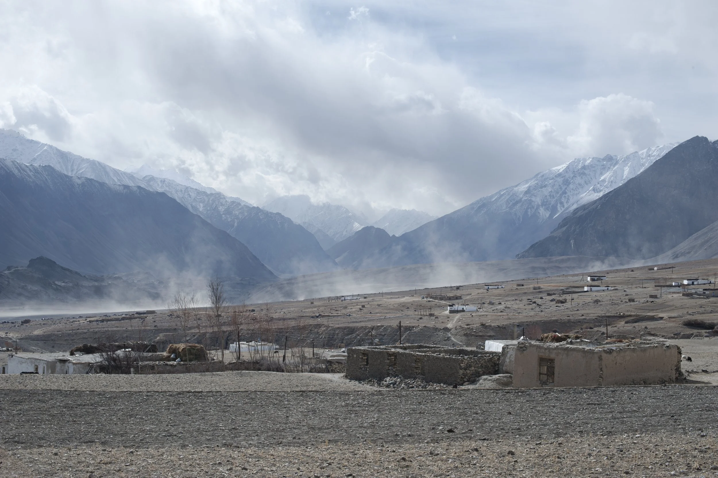 Dust rises above the village. The Pamir Mountains are a snowless desert. For Europeans dust is associated with the scorching sweltering summer, cracked earth parched by the sun. Here it is dusty all the time until the first snow falls.