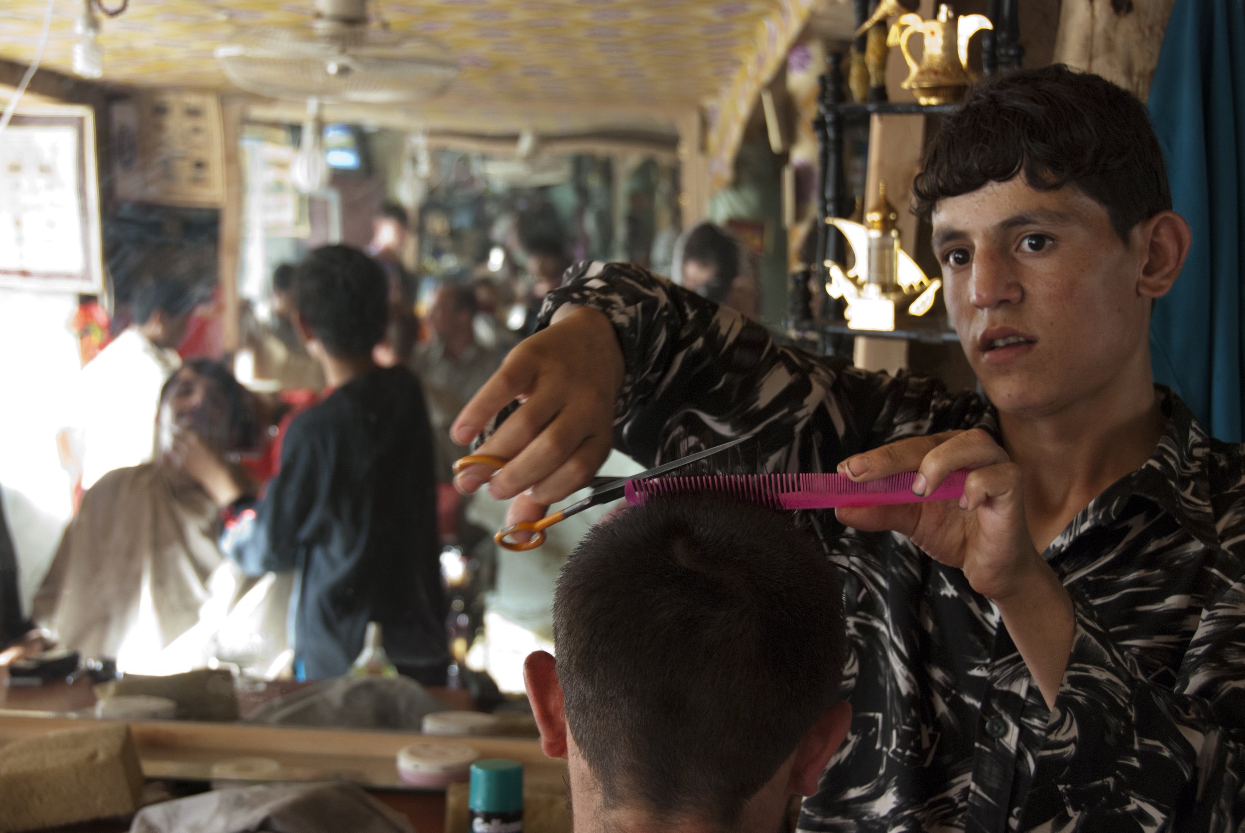 Beauty saloon, Faizabad 2011 A Hairdresser takes care of his client, The other massages his client beard. There is a long and proud tradition of beauty salons in Afghanistan, which were strictly forbidden during Taliban rule. Nowadays they are taking