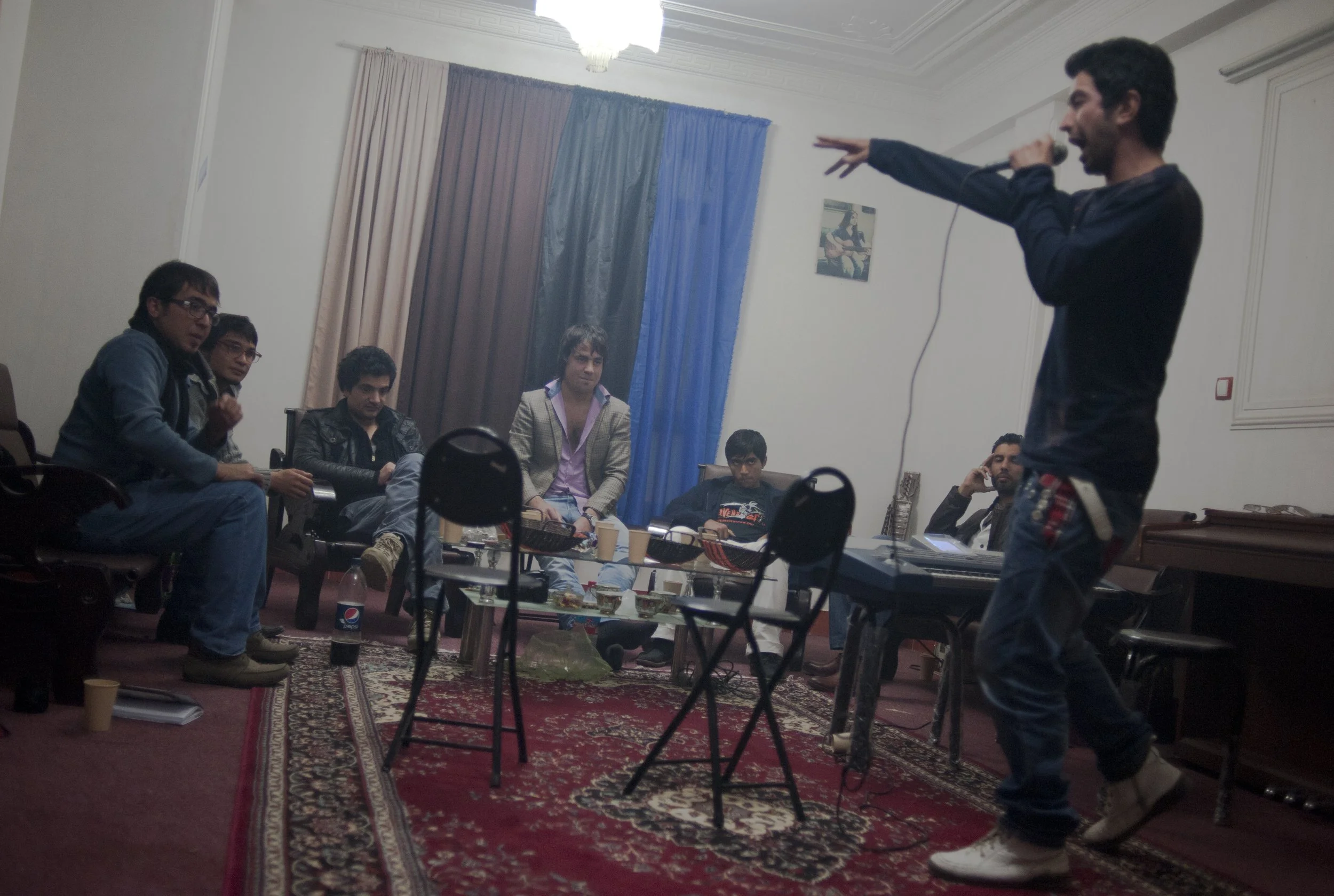 Music room, Herat 2012. Young Heratis gather in a music room to practice and socialize. A local rapper sings about his country.