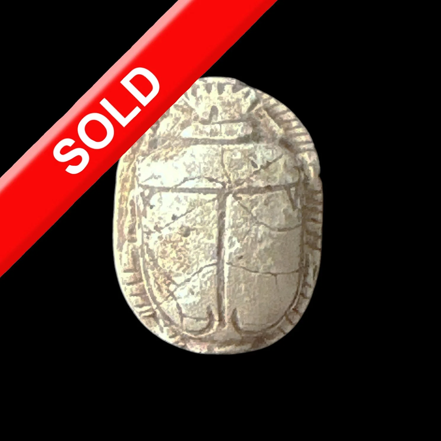 A silver coin with a tree engraved on it, placed against a black background, partially covered by a red banner with white text that reads 'SOLD'.