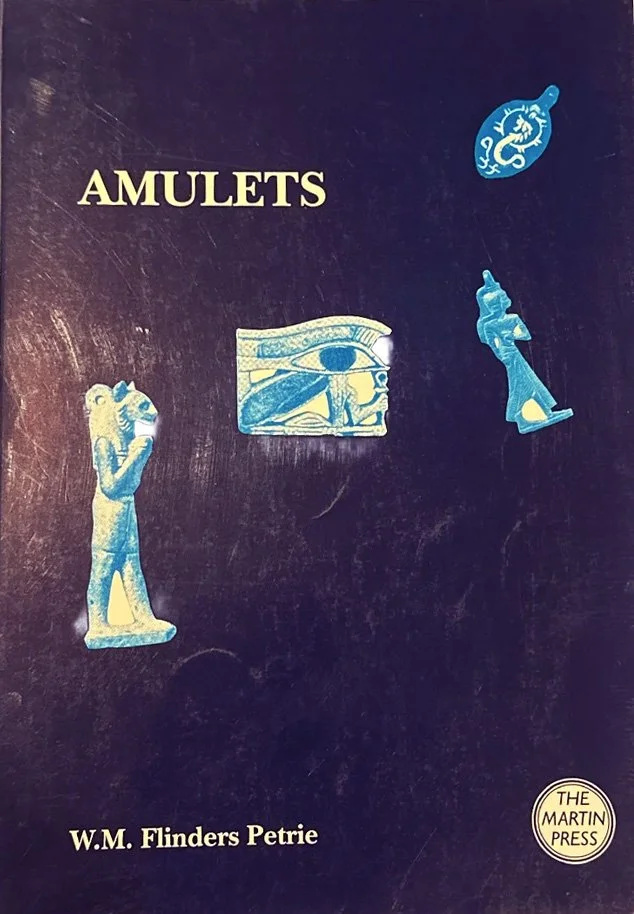 Cover of a book titled 'Amulets' by W.M. Flinders Petrie. The cover features images of various amulets, including a human figure, an eye, a seahorse, and a figure of a seated person. The publisher's logo, The Martyn Press, is in the bottom right corner.