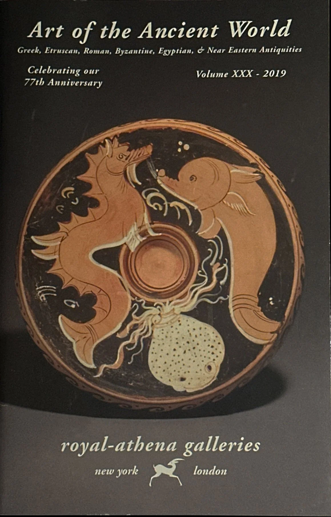 A magazine cover titled "Art of the Ancient World" featuring ancient Greek, Etruscan, Roman, Byzantine, Egyptian, and Near Eastern antiquities. The cover displays an ancient ceramic vessel with a depiction of a lion and a creature with a spiral shell, surrounded by decorative patterns. The publication details indicate it is Volume XXX from 2019, celebrating the 77th anniversary of the magazine, published by royal-athena galleries in New York and London.