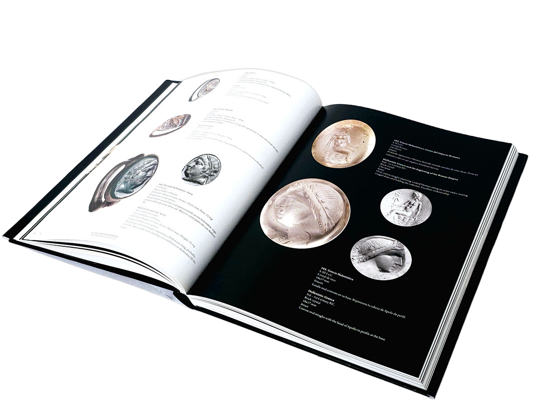 An open book displaying images and descriptions of ancient coins and artifacts.