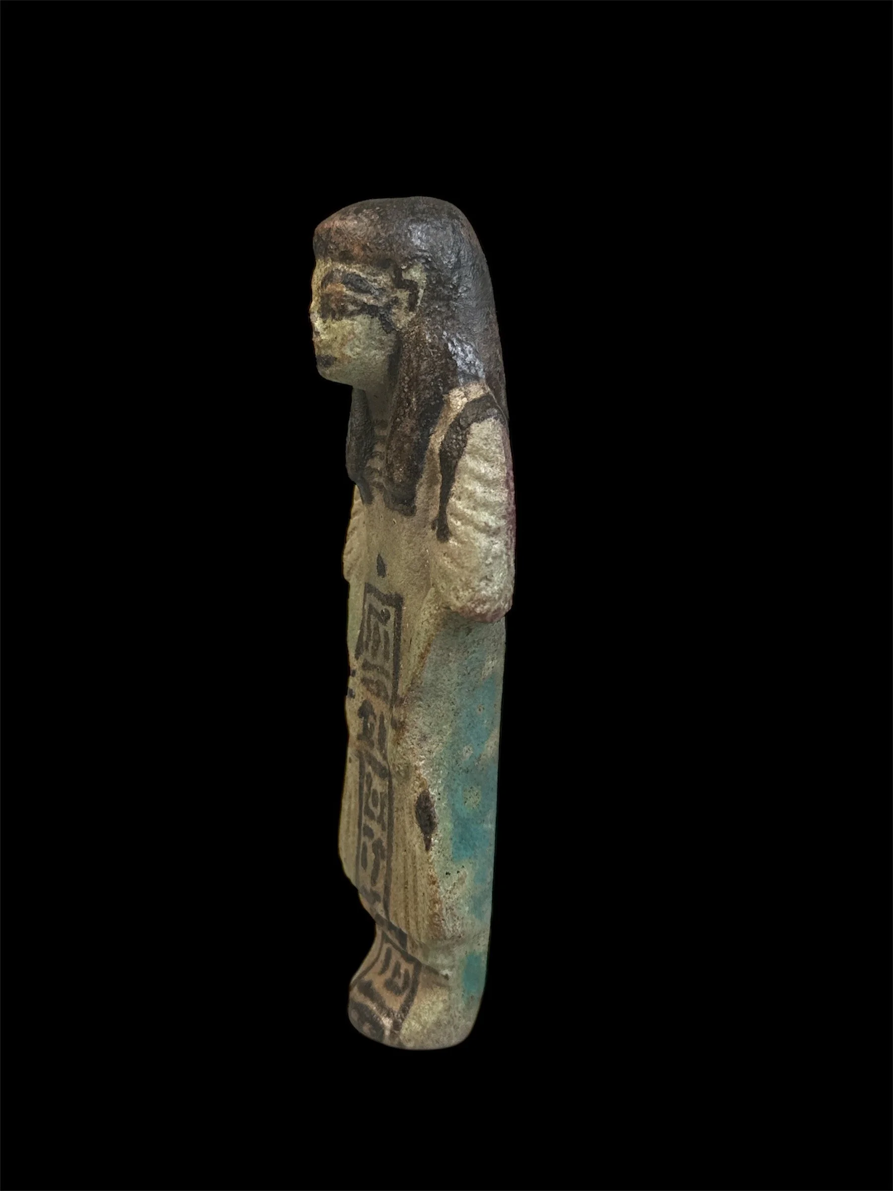 Ancient Egyptian artifact depicting a seated figure with detailed features and painted clothing.