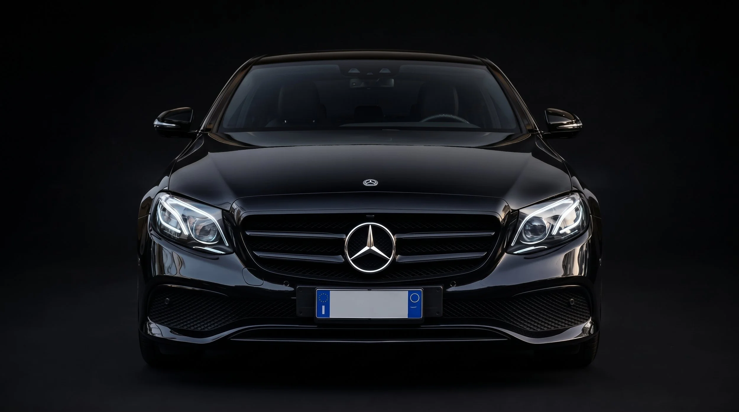 Front view of a sleek black Mercedes-Benz car against a dark background.
It's the E-Class Mercedes-Benz product for clients who want limo/executive chauffeur service for business trips.
