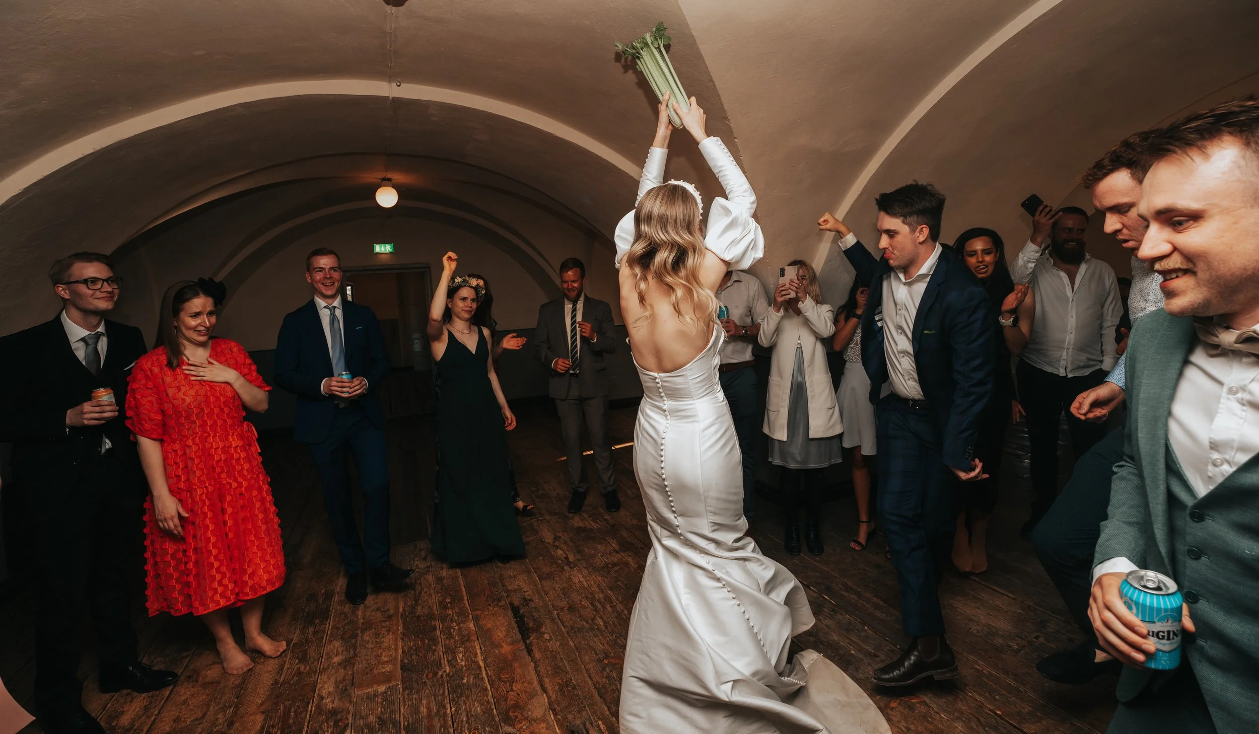Wedding celebration with bride throwing bouquet.
