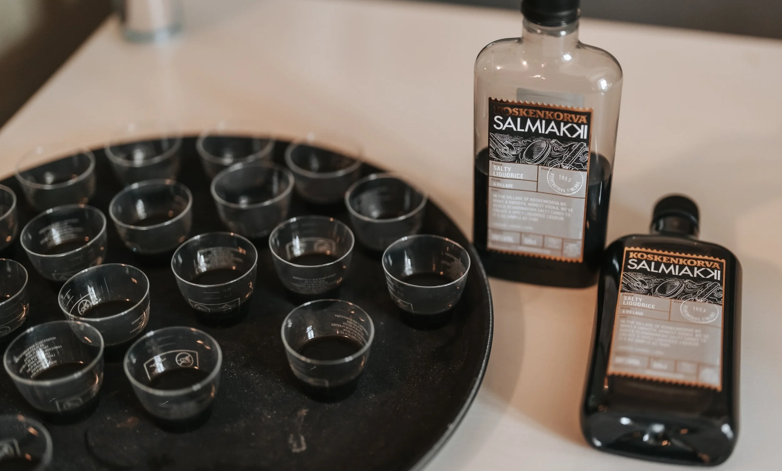 Koskenkorva Salmiakki bottles and filled shot glasses