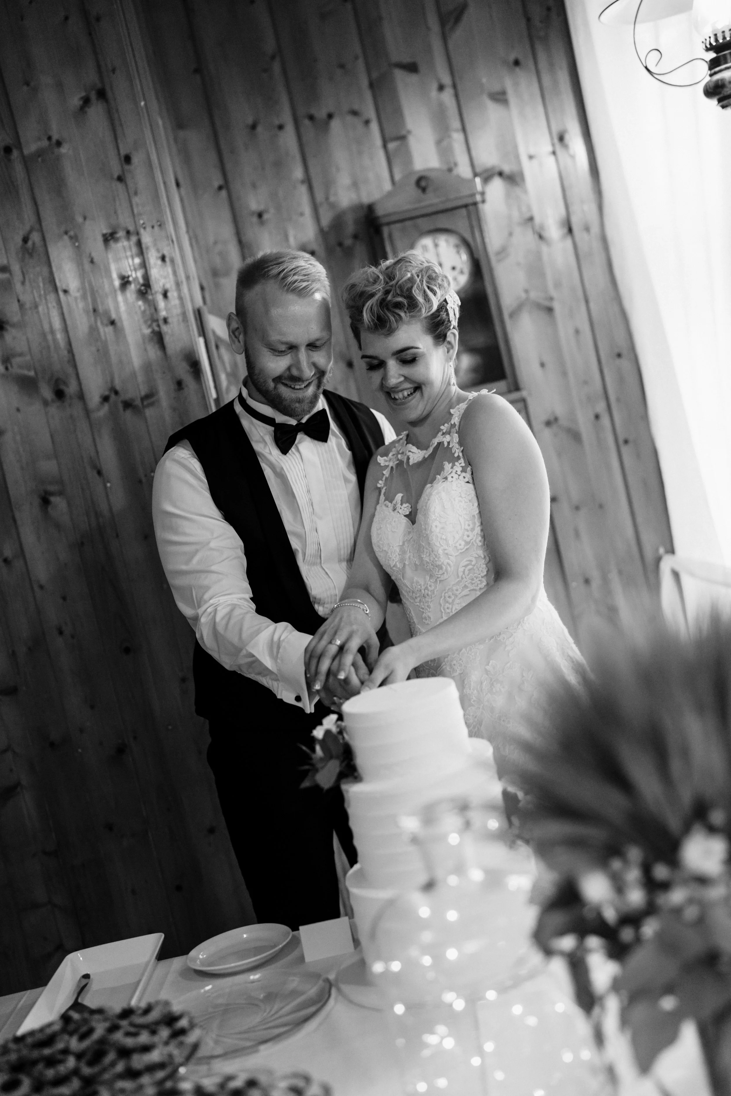 Bride and groom cutting wedding cake