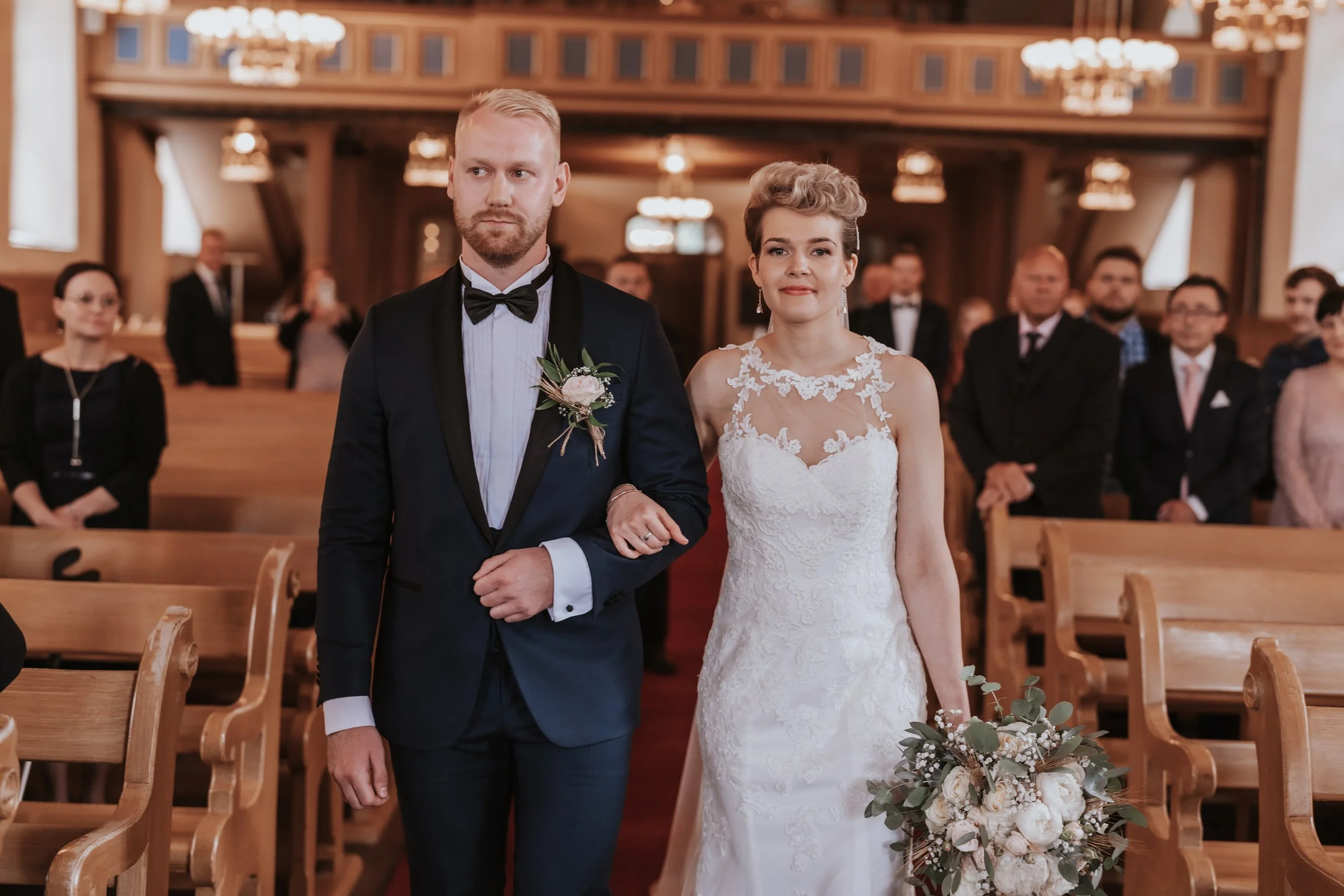 Bride and groom walking down the aisle in a church