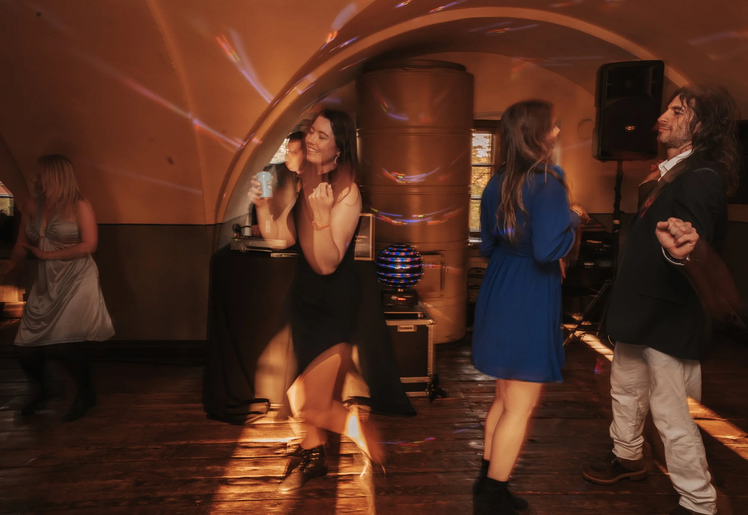 People dancing at a party with disco lights.