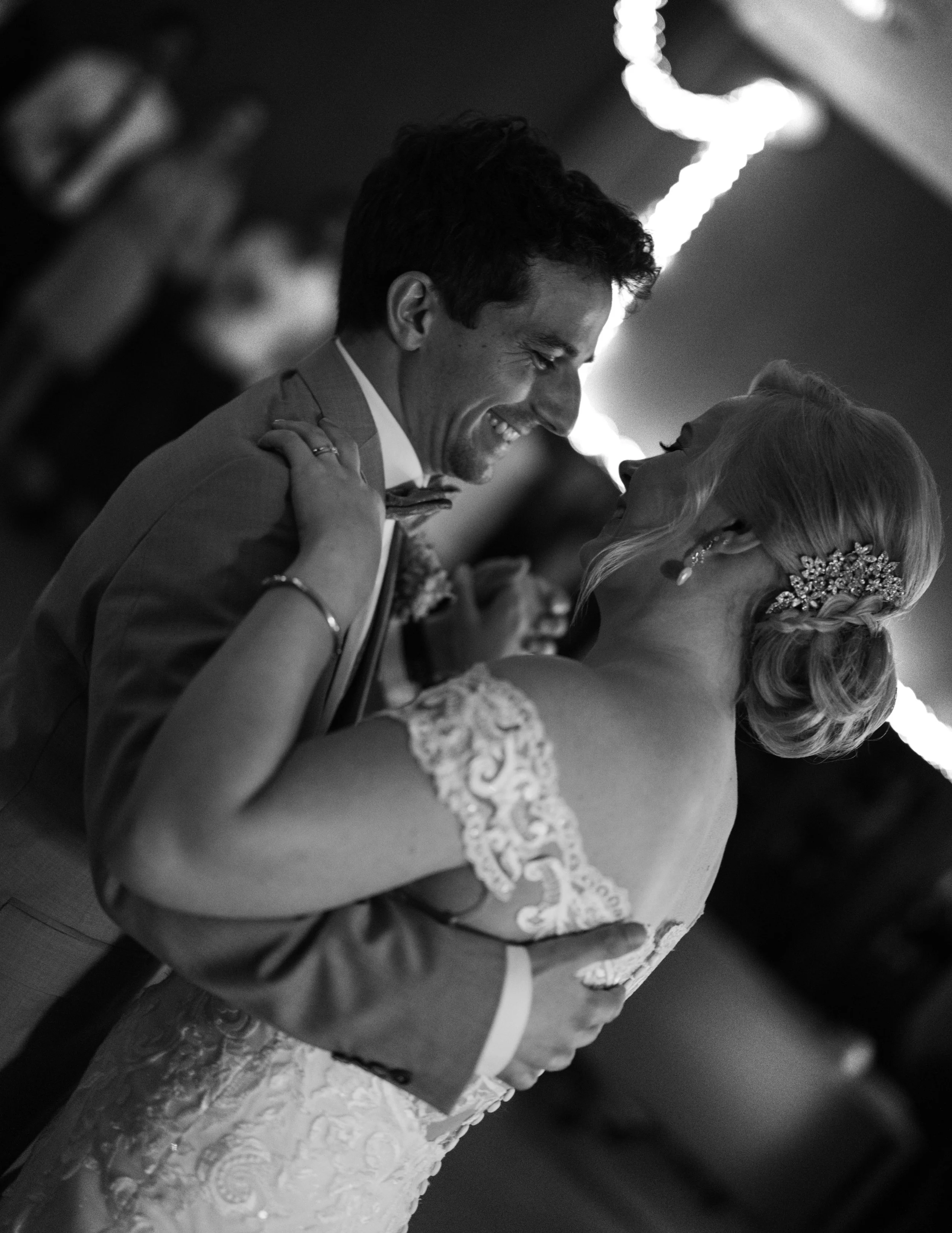 Black and white photo of a bride and groom dancing at their wedding
