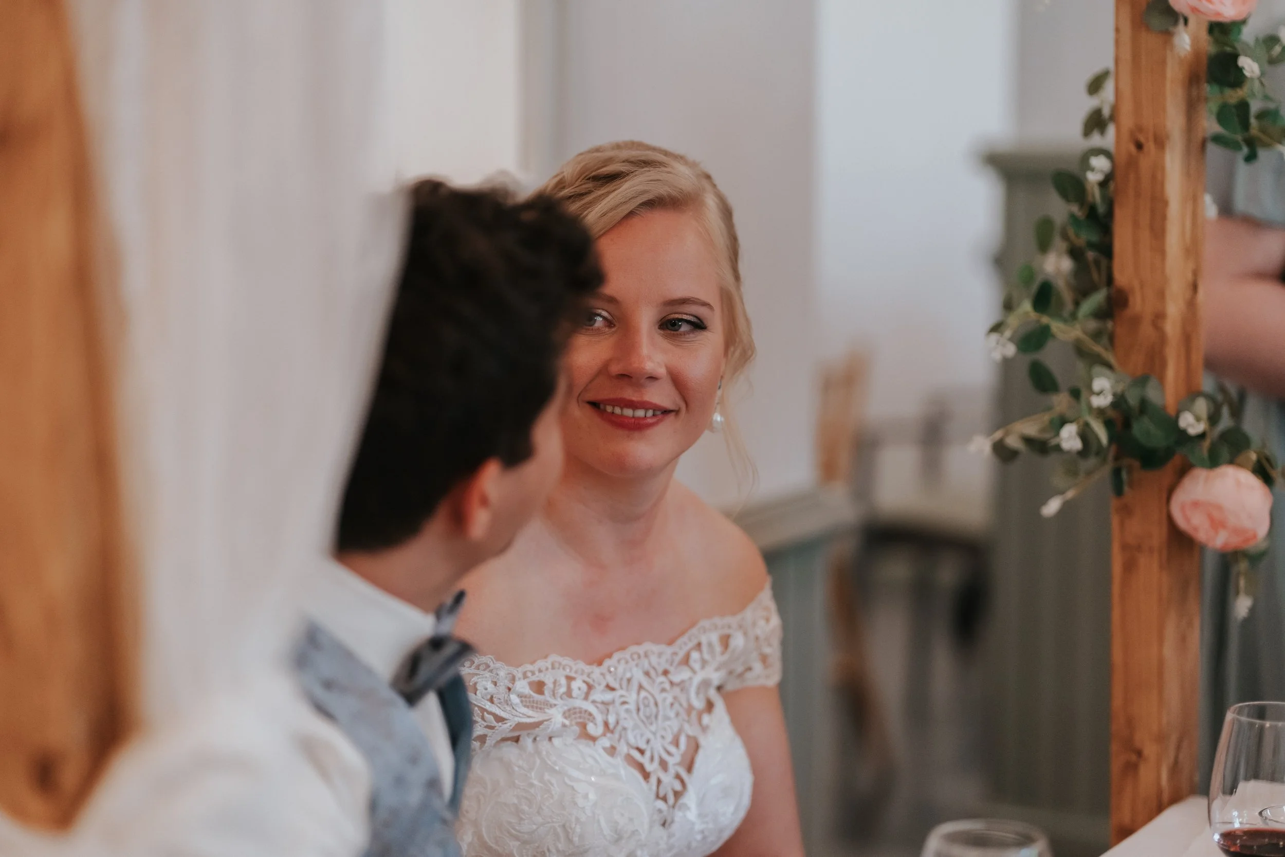 Bride and groom sitting together, bride smiling