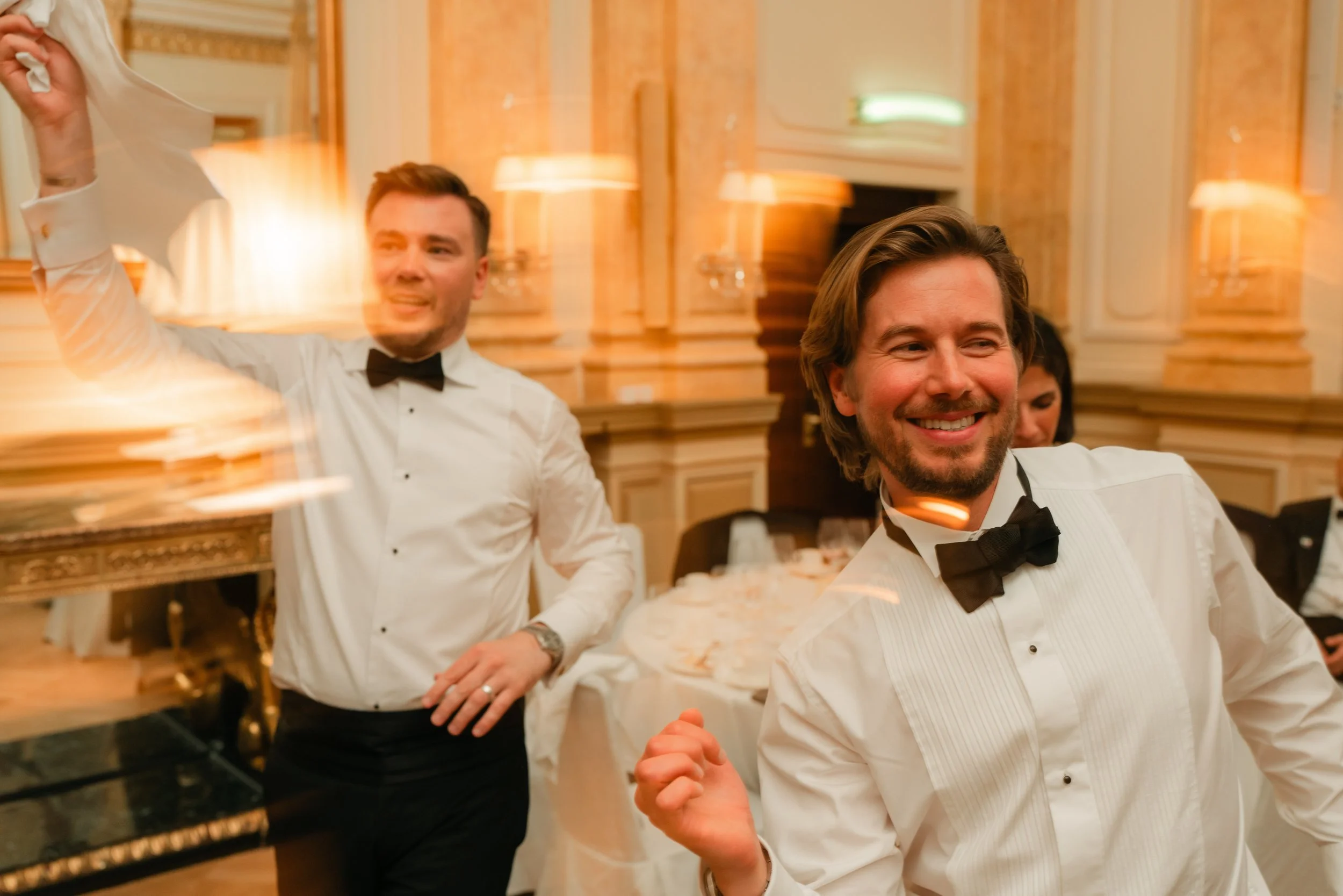 Men in tuxedos dancing at a formal event.