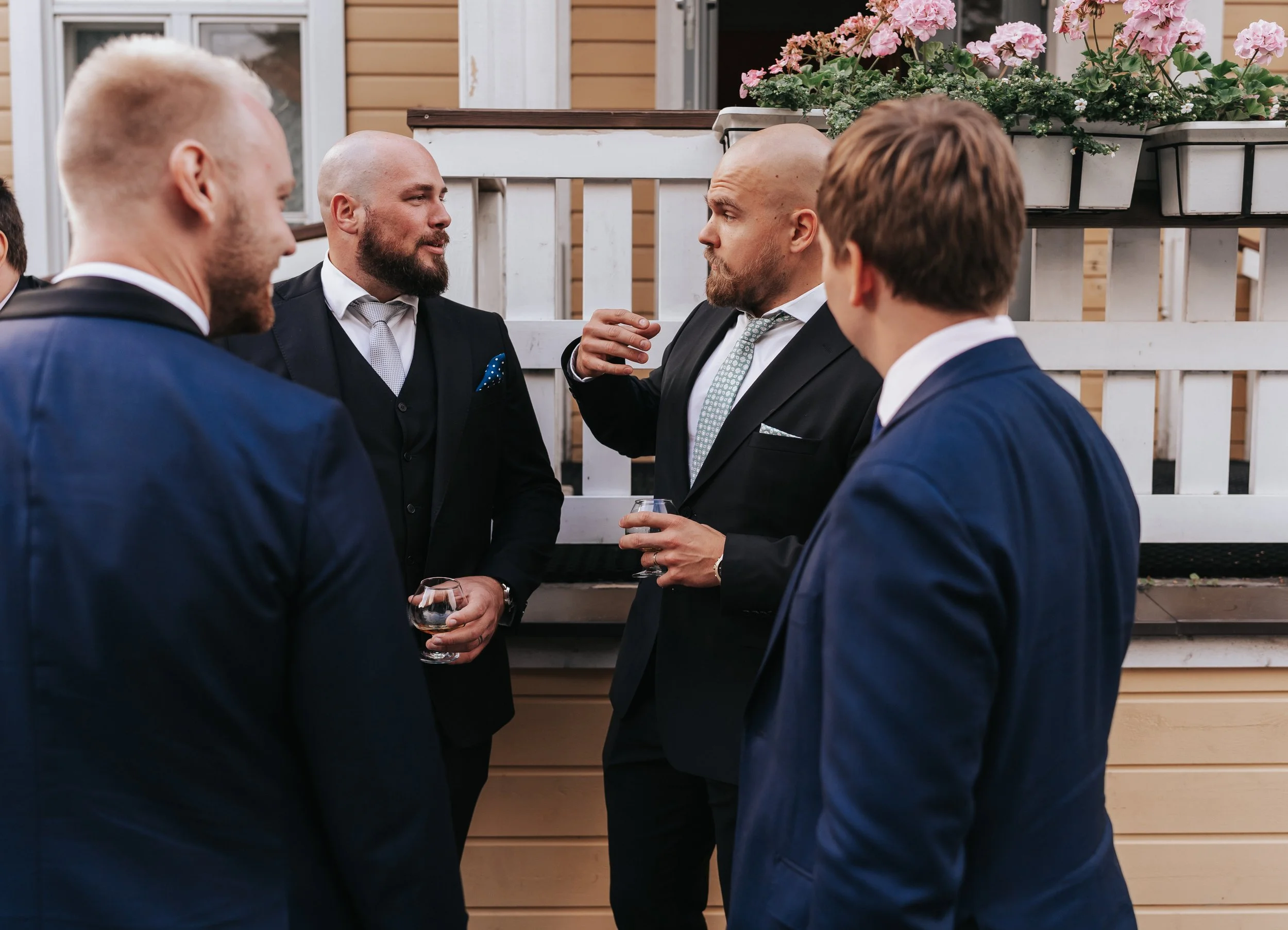 Group of men in suits having a conversation outdoors