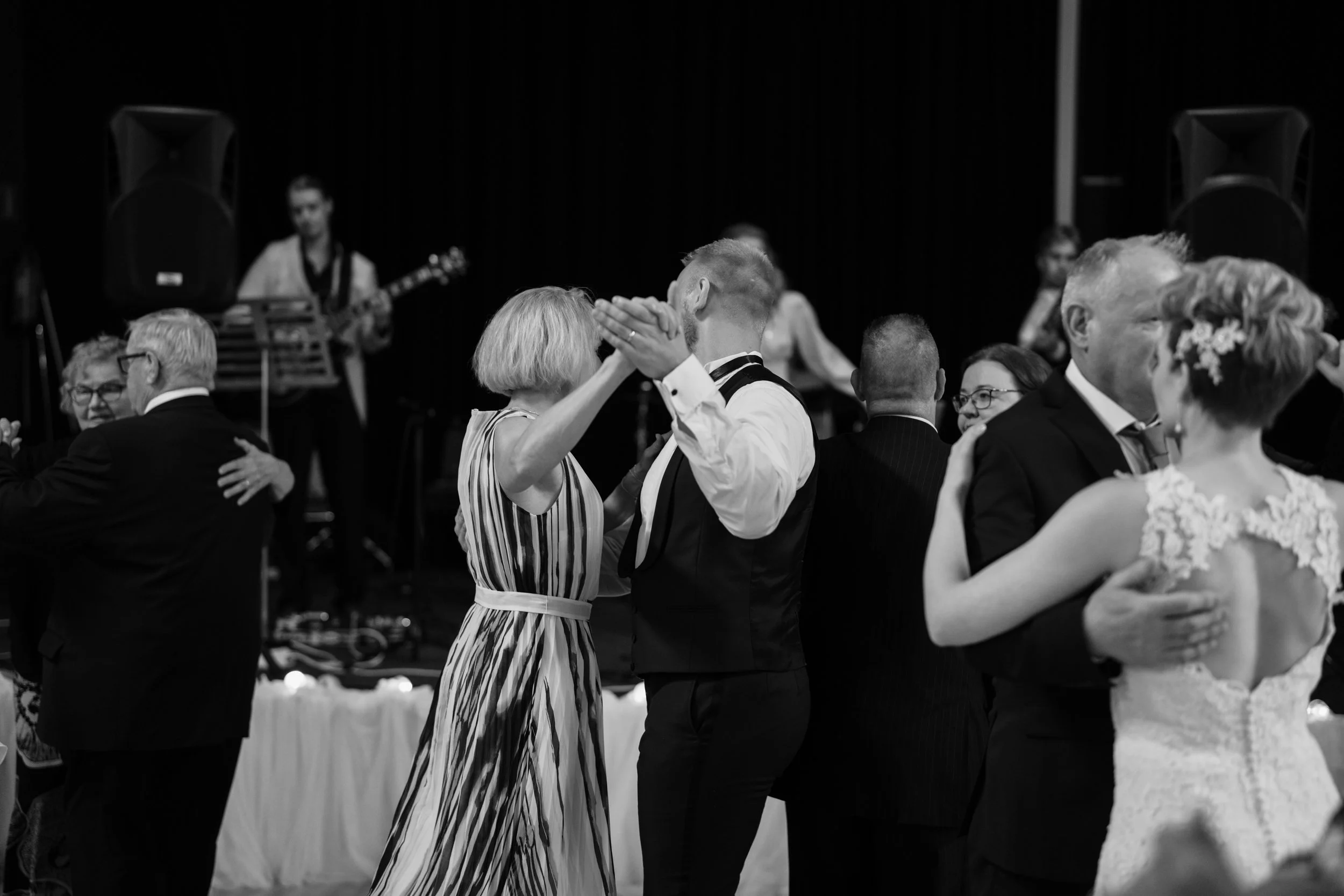 Black and white photo of multiple couples dancing at a formal event.