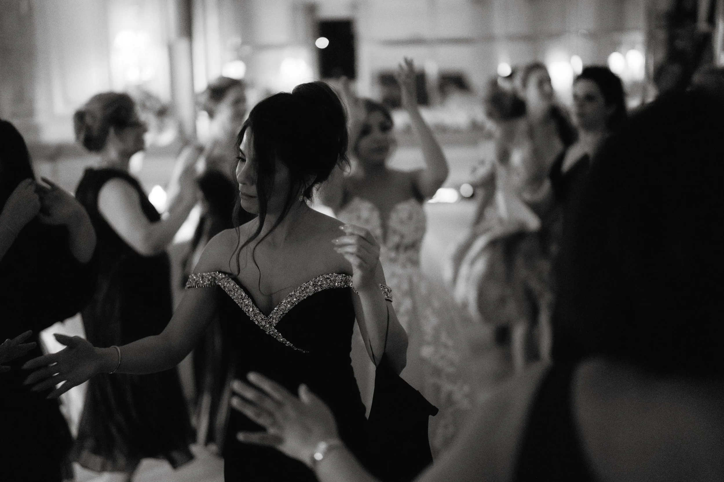 People dancing in formal attire at an event, black and white photo.