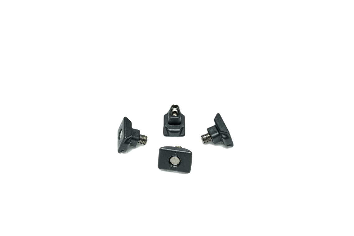 Four black T-slot nuts on white background.
