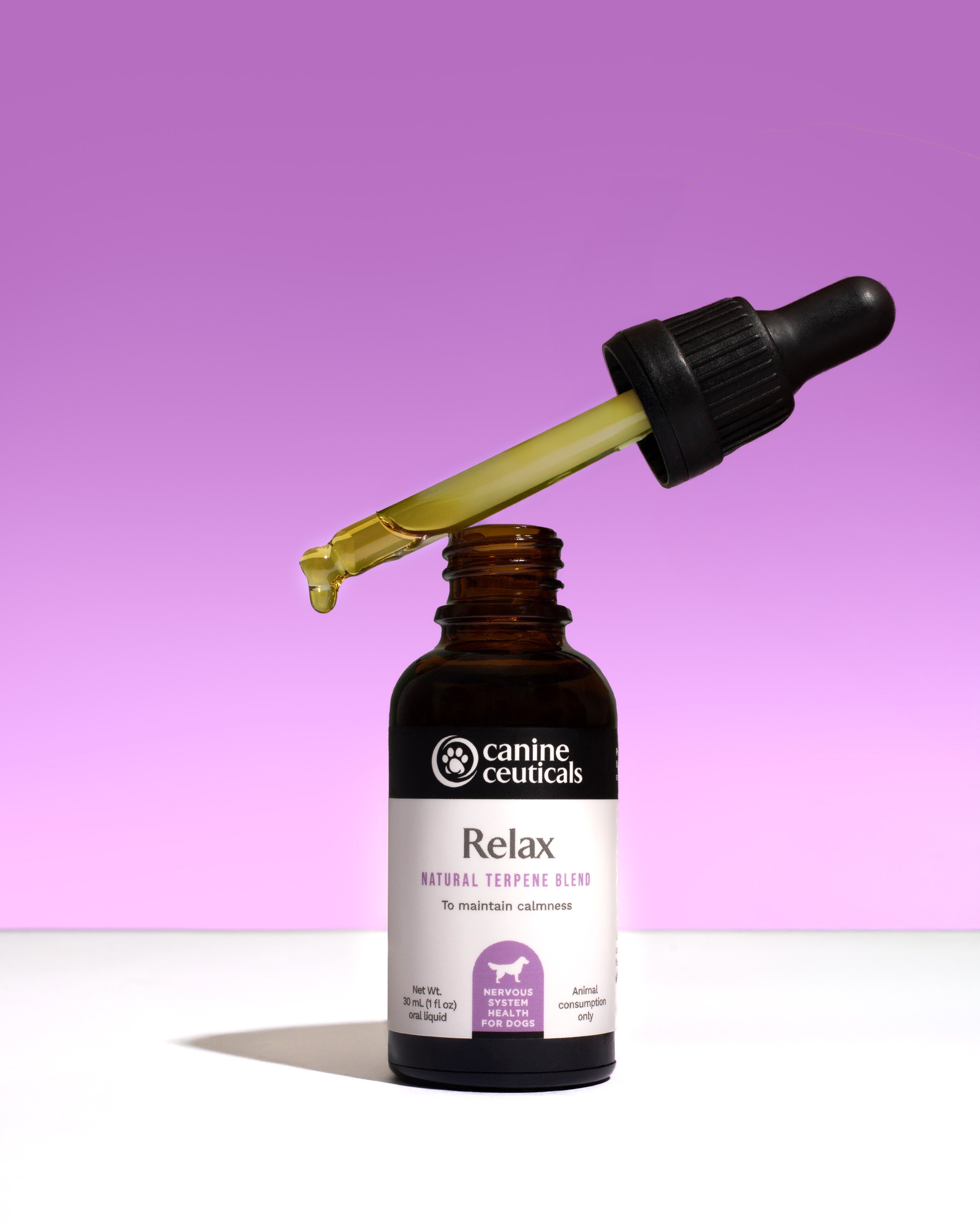 A small brown dropper bottle labeled "Relax Natural Terpene Blend" with a black dropper cap. The dropper is filled with yellow liquid, with a droplet about to fall. The background is purple.
