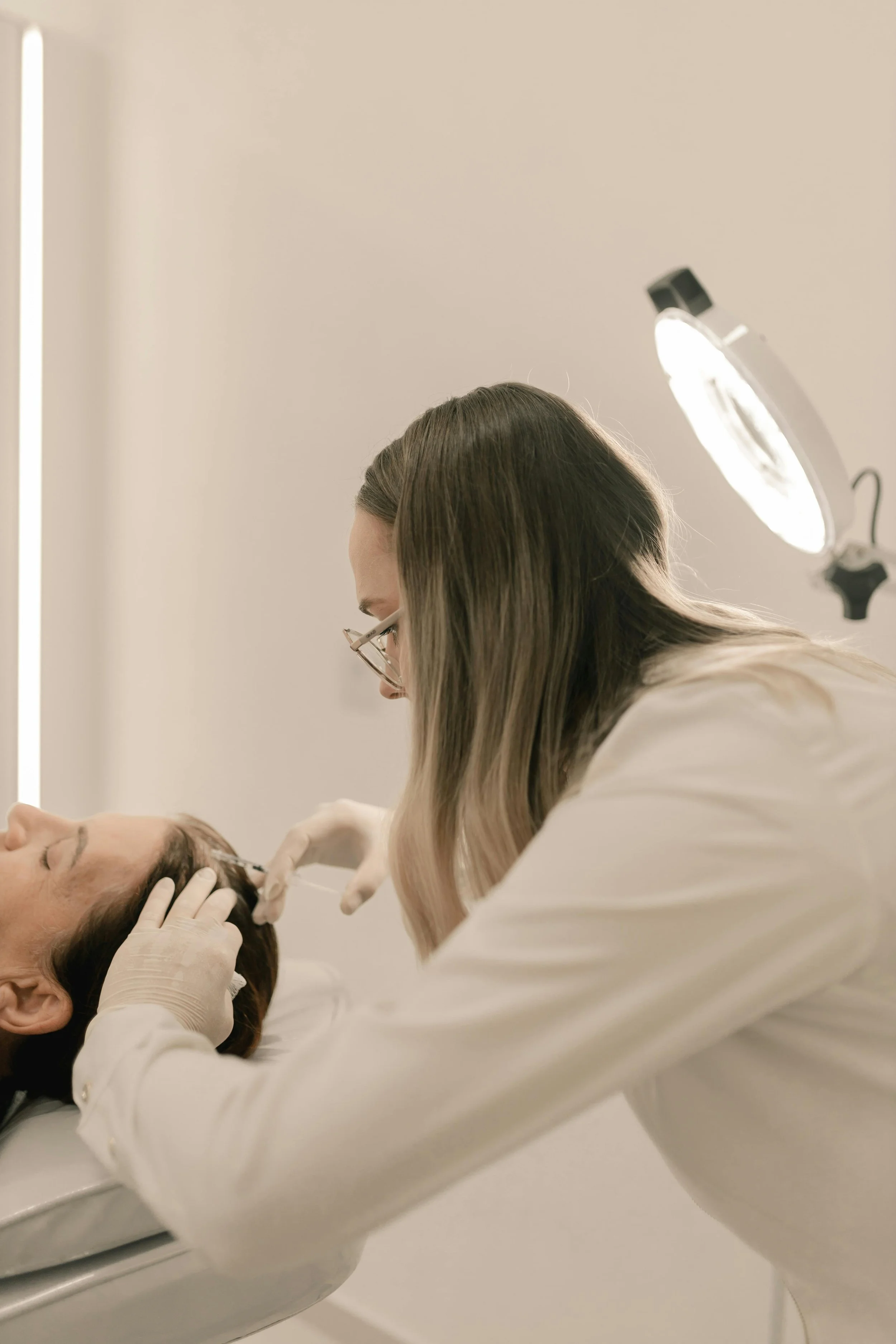 Practitioner performing advanced hair restoration treatment at Harley Street medical clinic in London