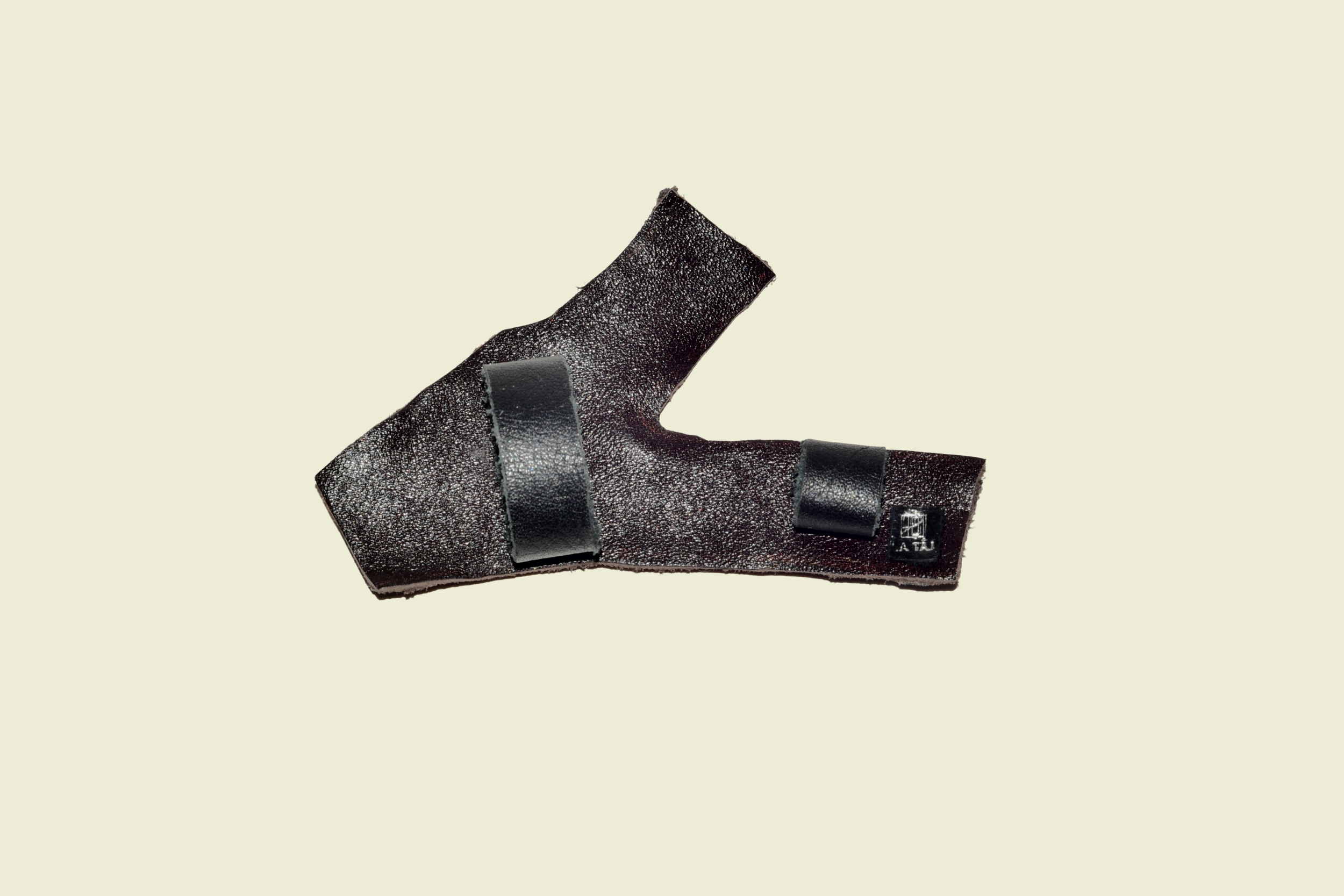 Back view of handmade La Taj eyewear jewellery in black leather with brown accents and off-white leather supports designed to slide onto eyewear frames.
