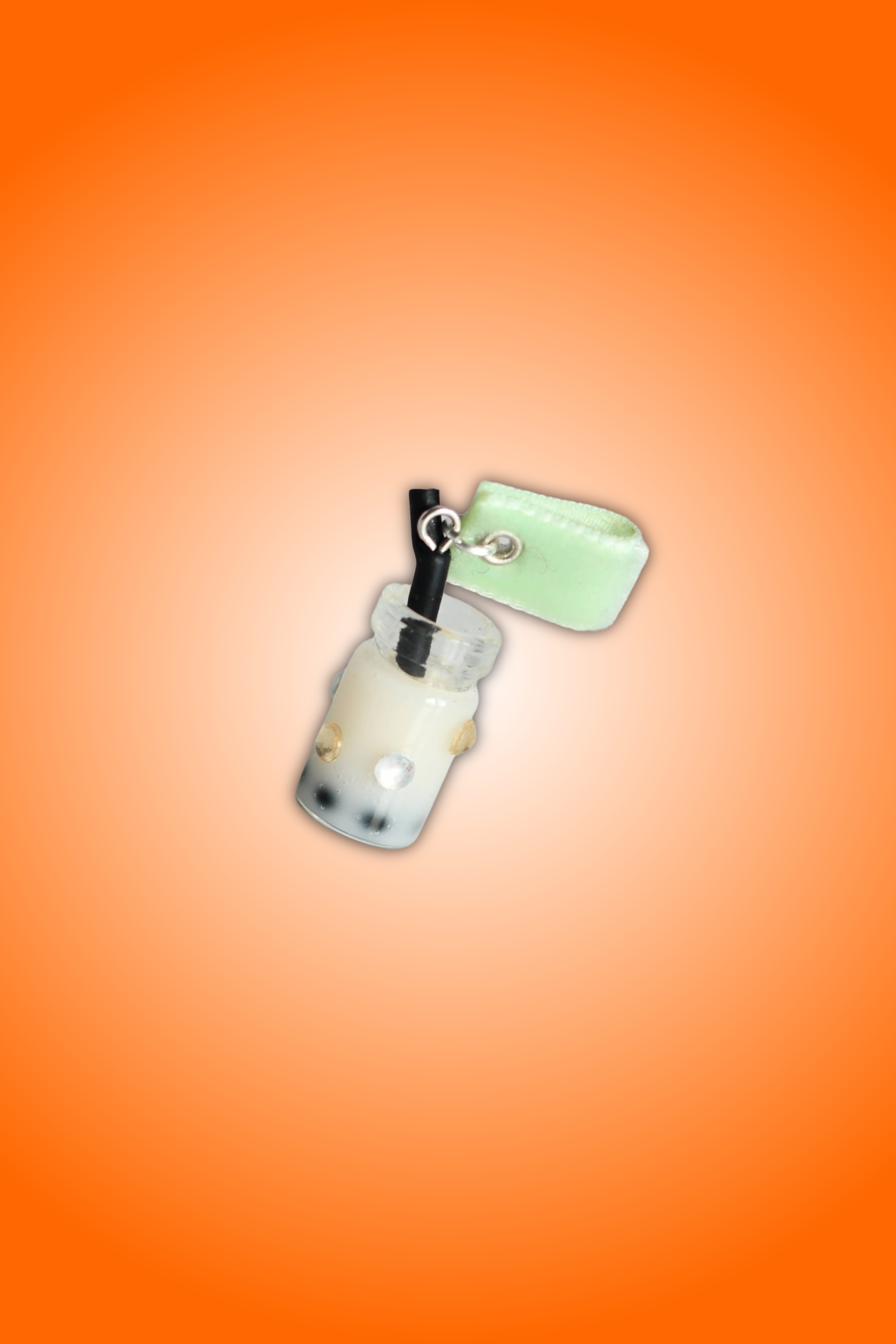 Mango Boba Tea Charm attached to mint green soft fabric with transparent and light yellow diamonds