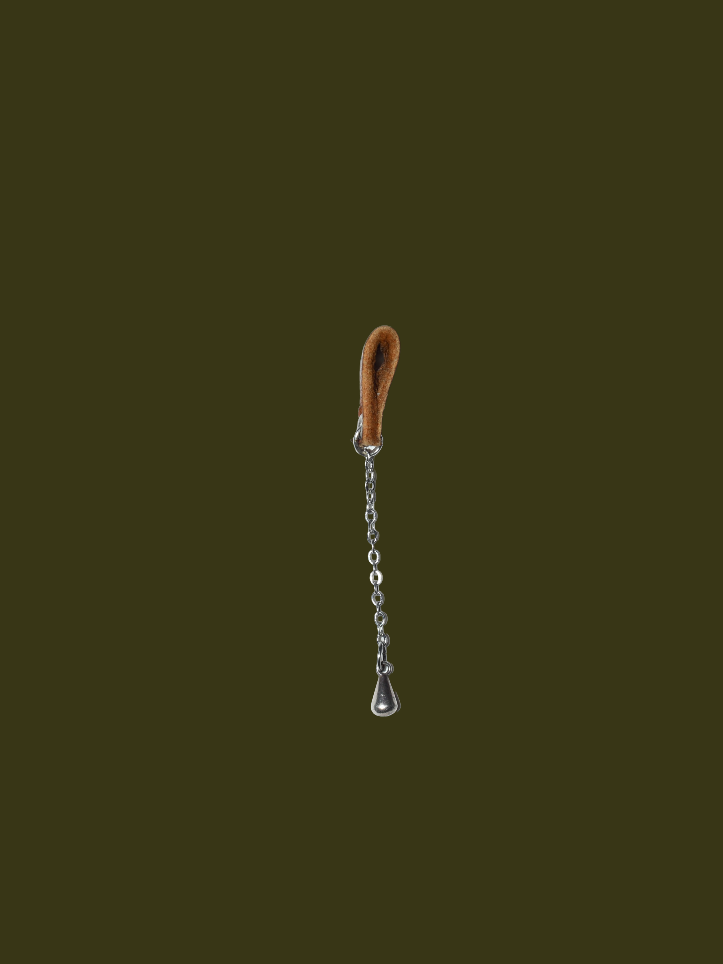 side profile. slide on eyeglasses jewellery made of silver plated charm attached to organic brown leather holder2026 at 16.43.20 (3).png