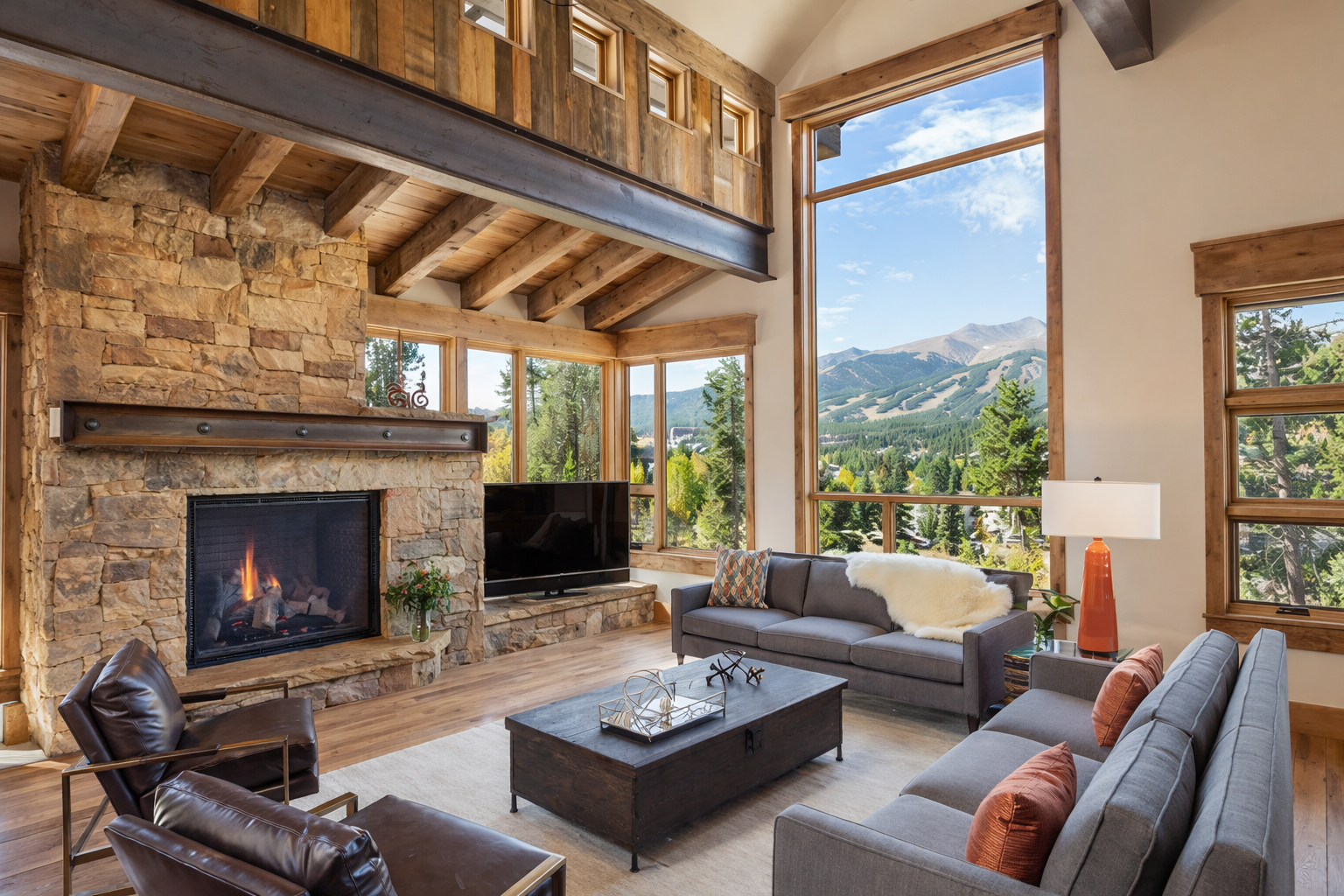 Luxury mountain home interior with stone fireplace and Rocky Mountain views by Gold Hill Builders Evergreen CO