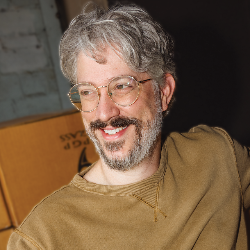 Artist and graphic designer David Samford smiling in front of a white background