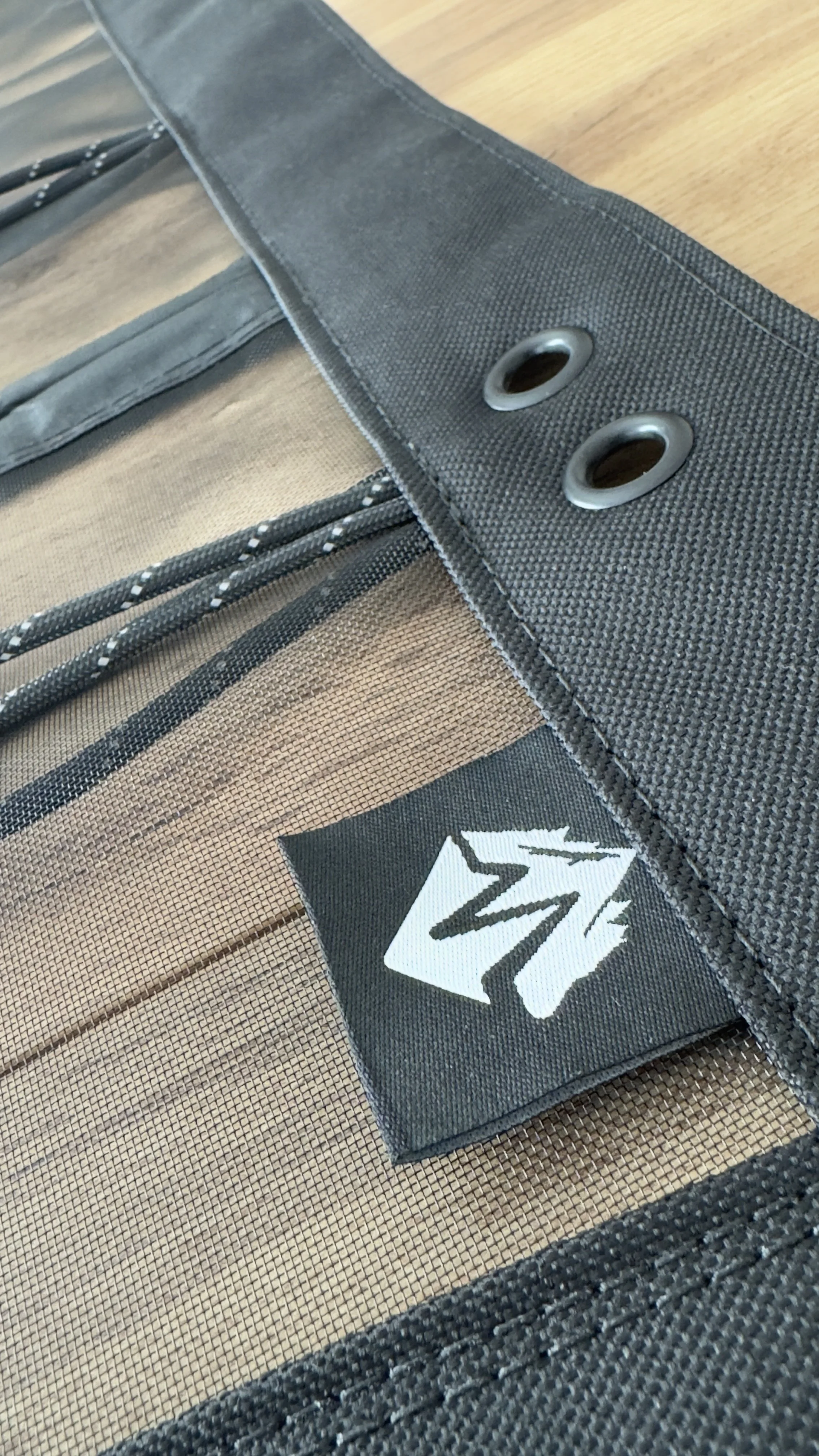 Close-up of a section of a bug screen for a Topo Toppers Camper access hatch with the Made For Wheelers logo.