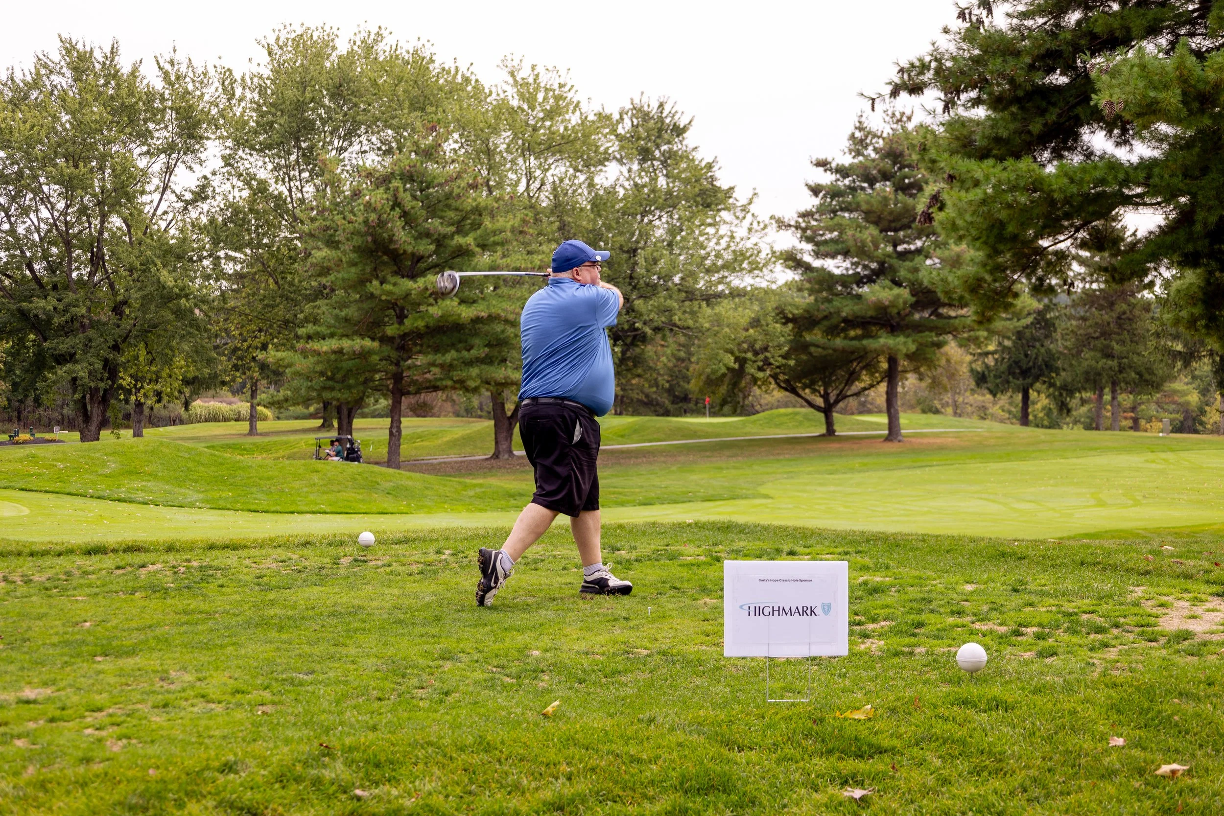 Event photography from a nonprofit golf outing, documenting golfers, course details, group moments, and candid interactions throughout the day in a natural, documentary style.
