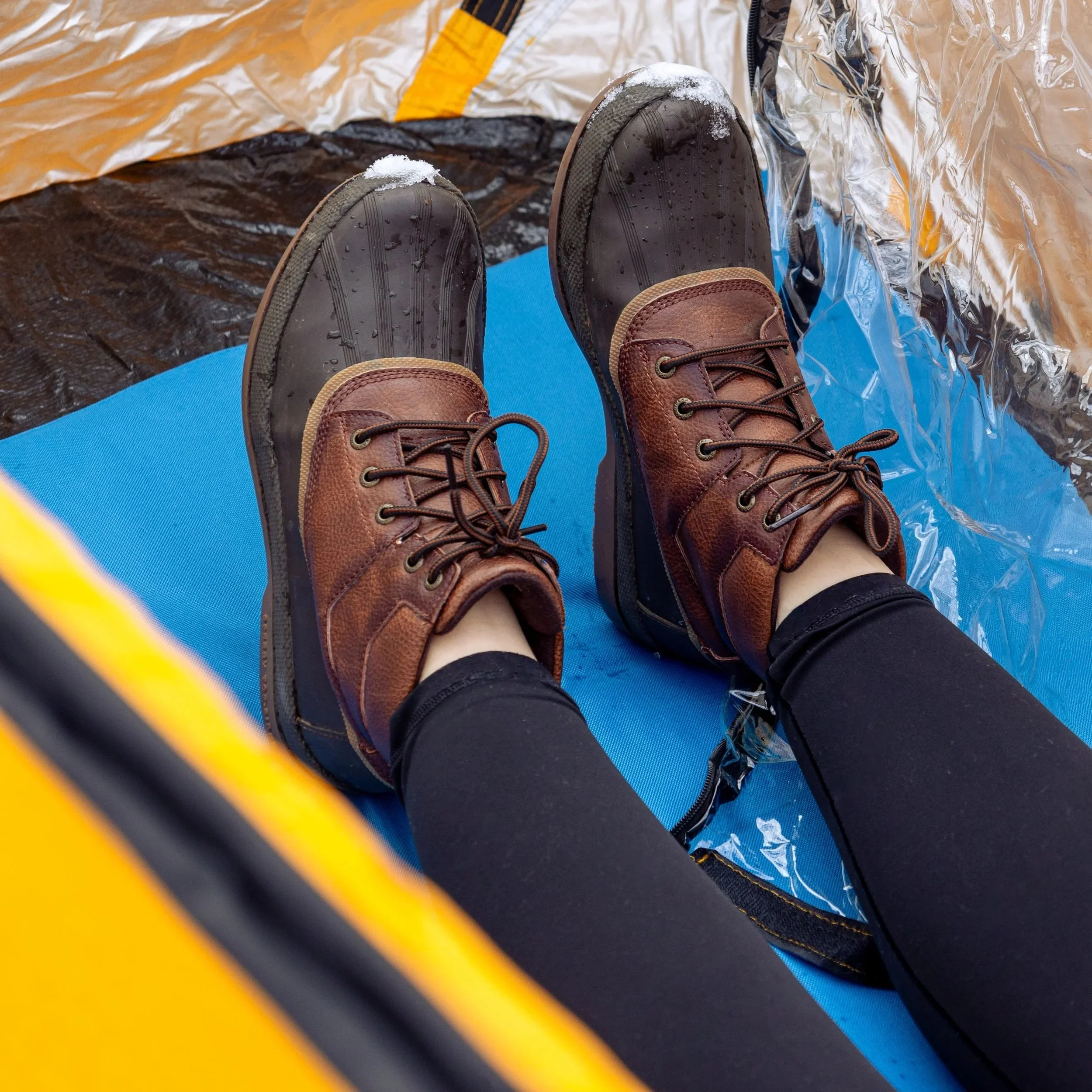Lifestyle product photography featuring the SunHugg pop-up outdoor shelter, captured in a natural winter setting. Images highlight real-world use, setup and breakdown, interior details, branding elements, and scale to demonstrate functionality, porta