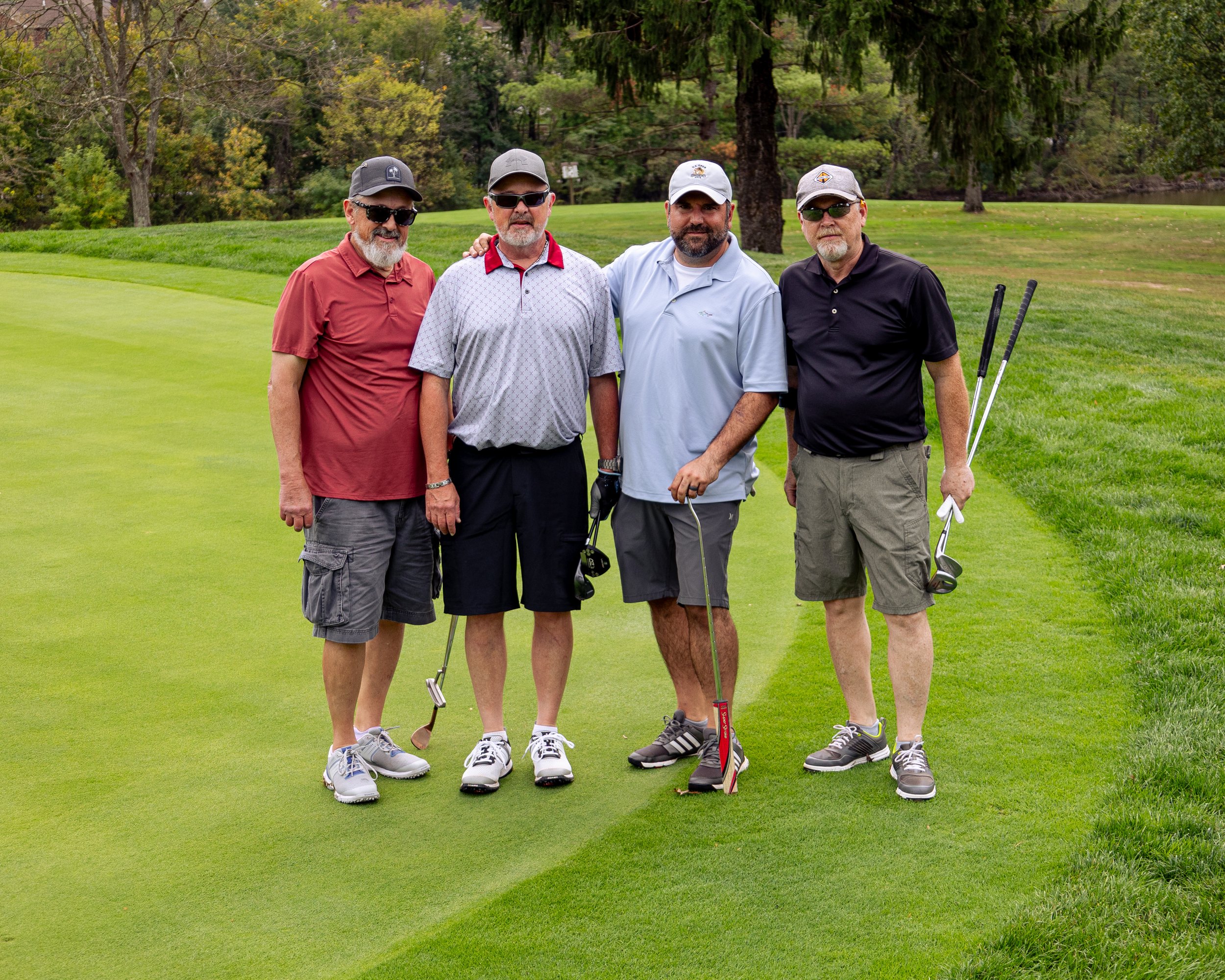 Event photography from a nonprofit golf outing, documenting golfers, course details, group moments, and candid interactions throughout the day in a natural, documentary style.