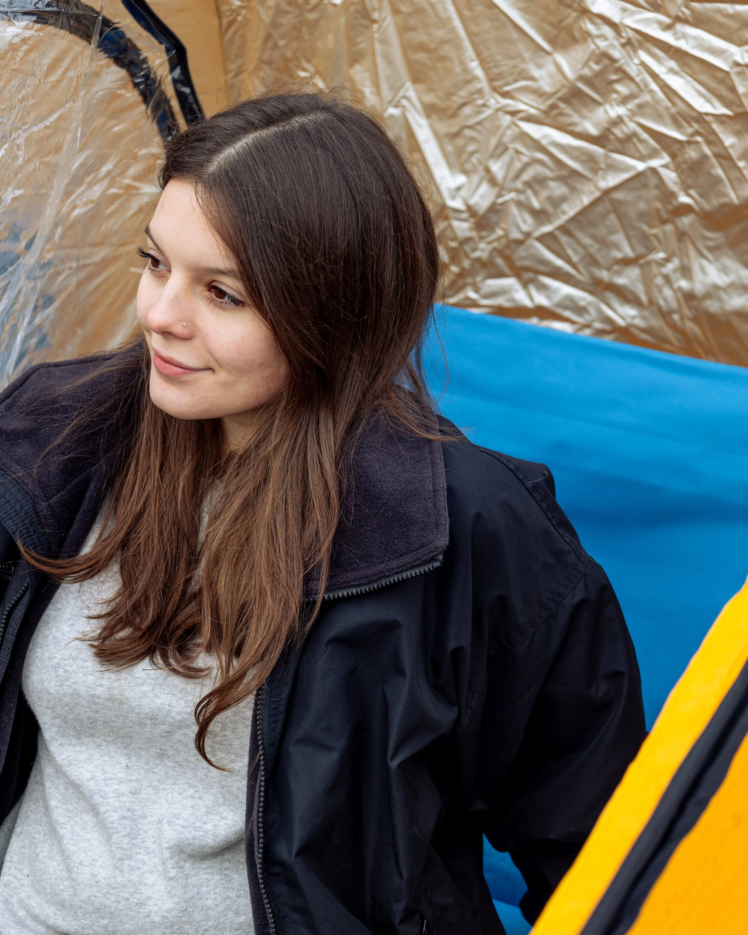 Lifestyle product photography featuring the SunHugg pop-up outdoor shelter, captured in a natural winter setting. Images highlight real-world use, setup and breakdown, interior details, branding elements, and scale to demonstrate functionality, porta