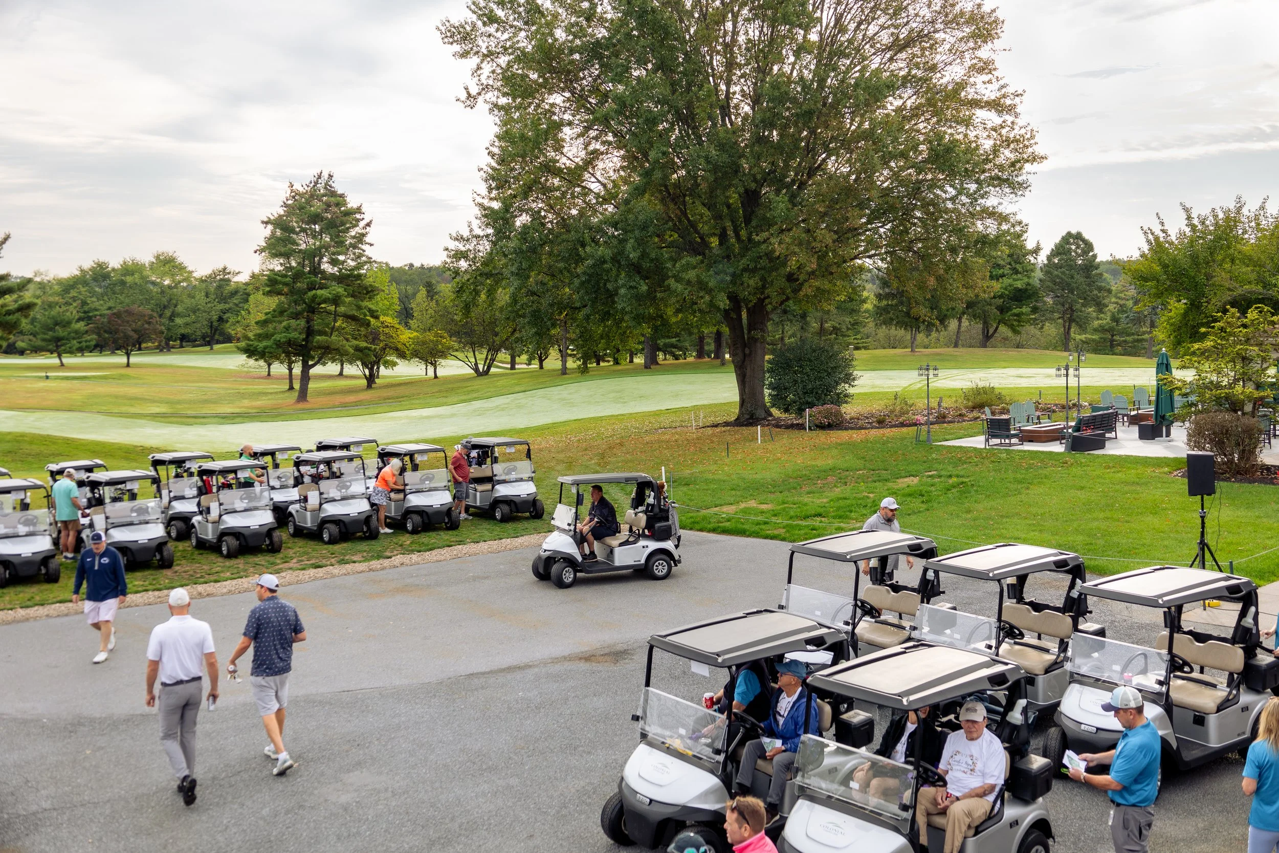 Event photography from a nonprofit golf outing, documenting golfers, course details, group moments, and candid interactions throughout the day in a natural, documentary style.