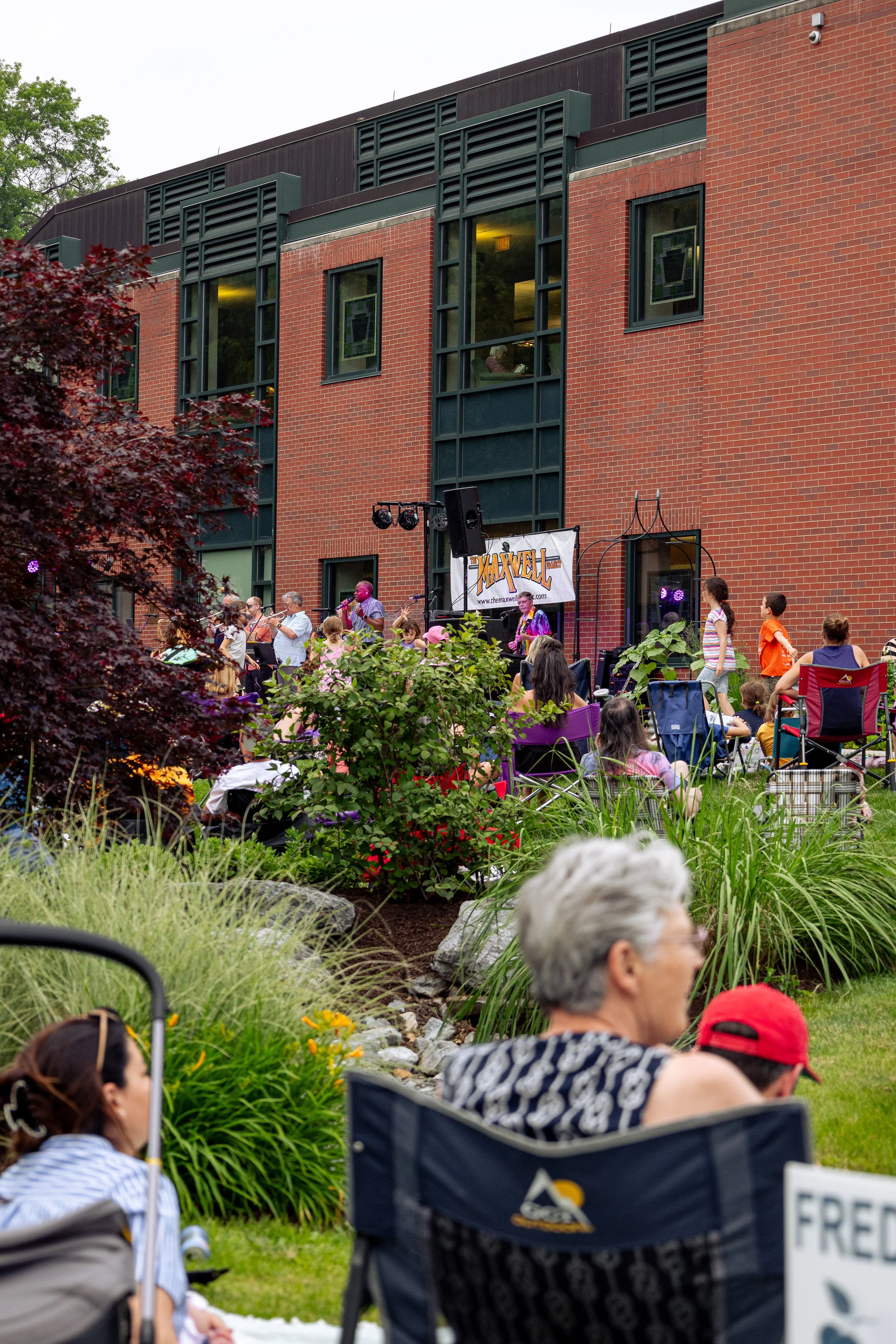 Outdoor summer concert featuring the Maxwell band at Cleve J. Fredricksen Library