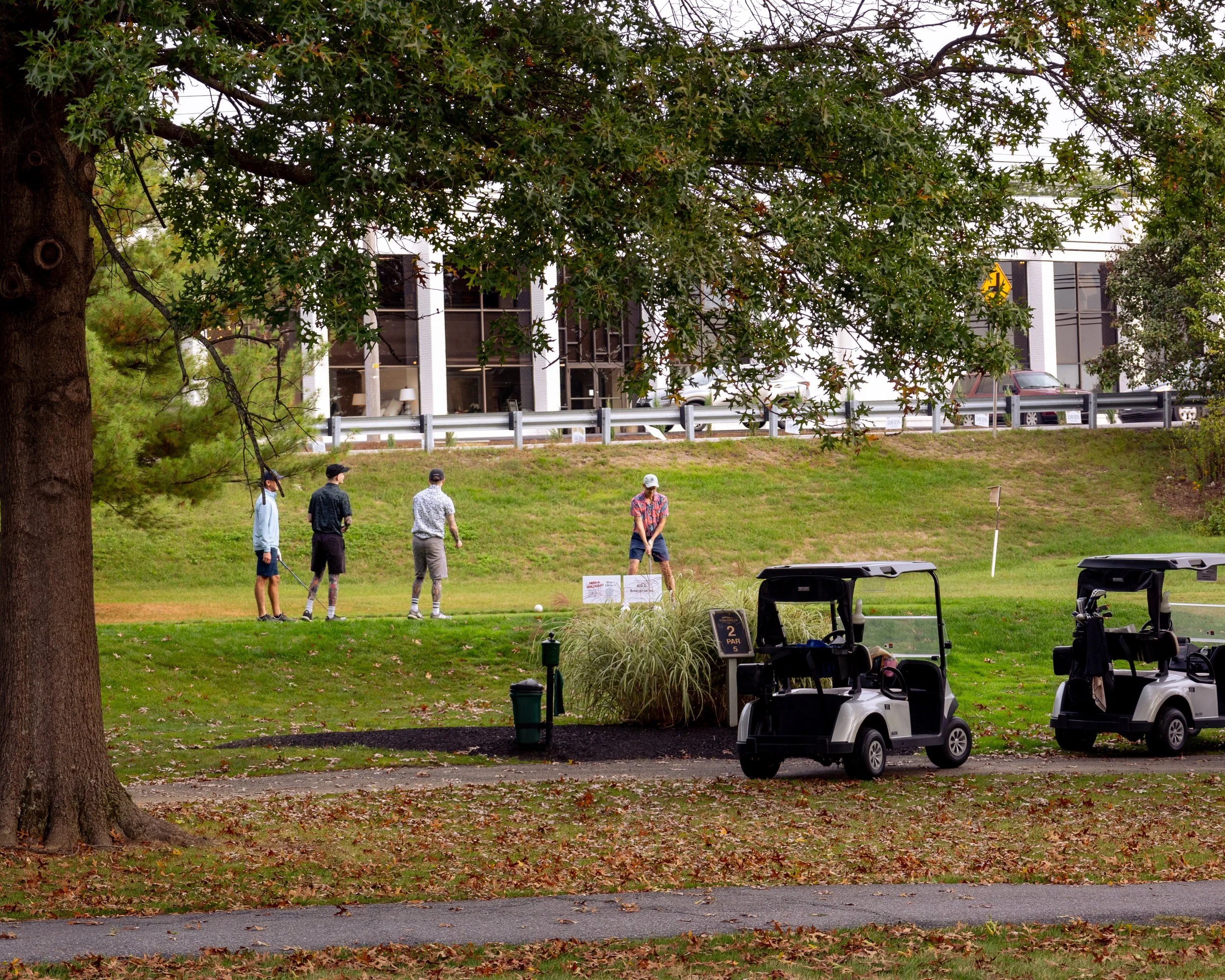 Event photography from a nonprofit golf outing, documenting golfers, course details, group moments, and candid interactions throughout the day in a natural, documentary style.