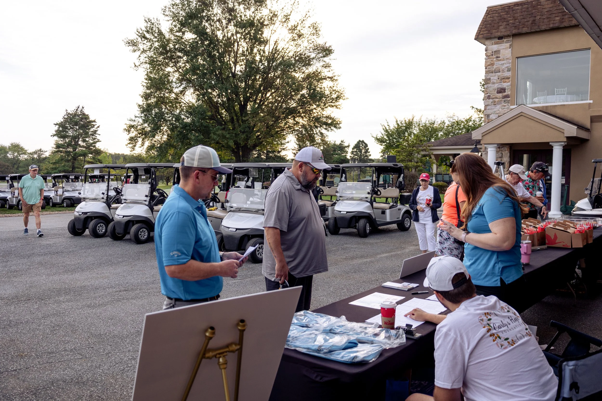 Event photography from a nonprofit golf outing, documenting golfers, course details, group moments, and candid interactions throughout the day in a natural, documentary style.