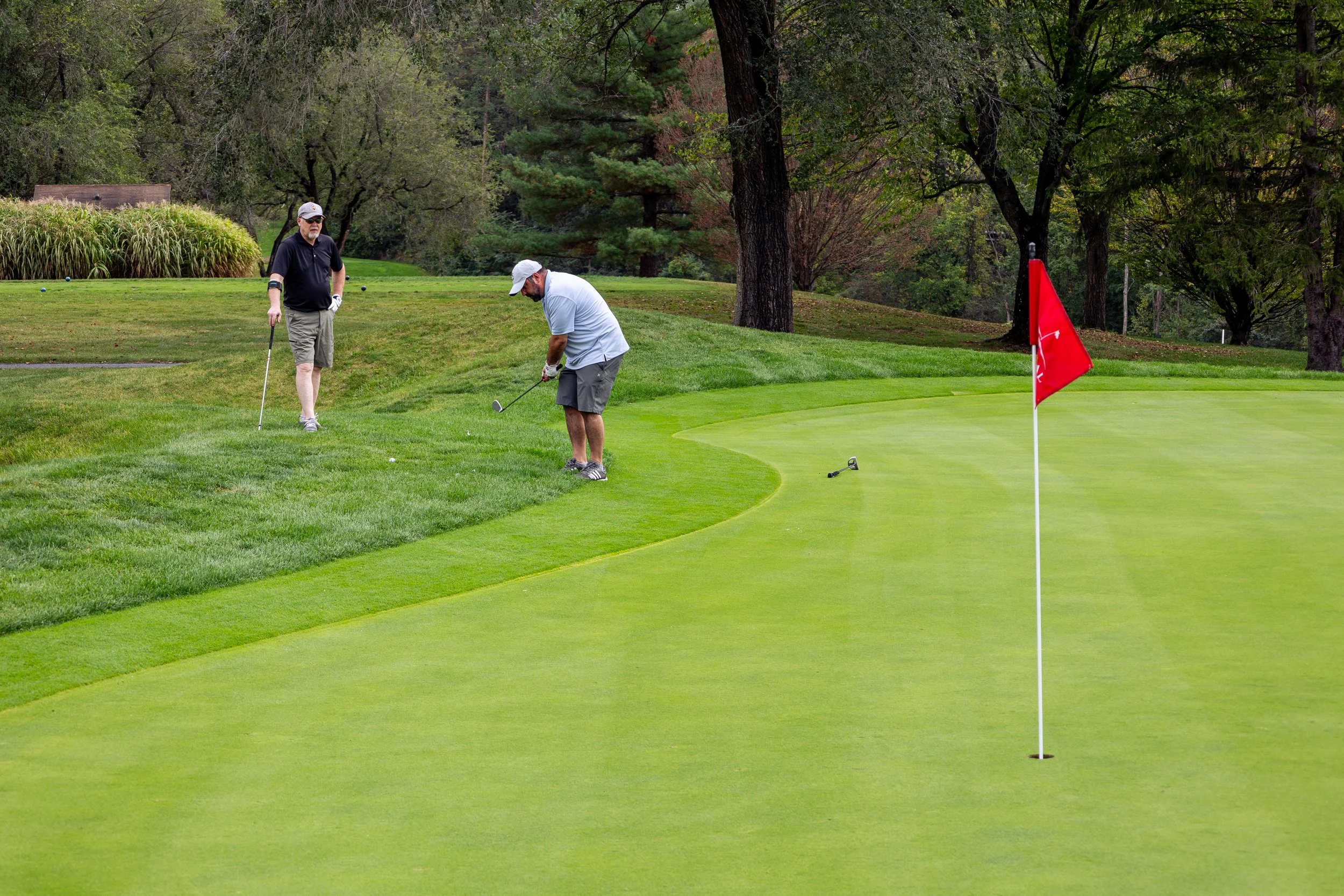 Event photography from a nonprofit golf outing, documenting golfers, course details, group moments, and candid interactions throughout the day in a natural, documentary style.