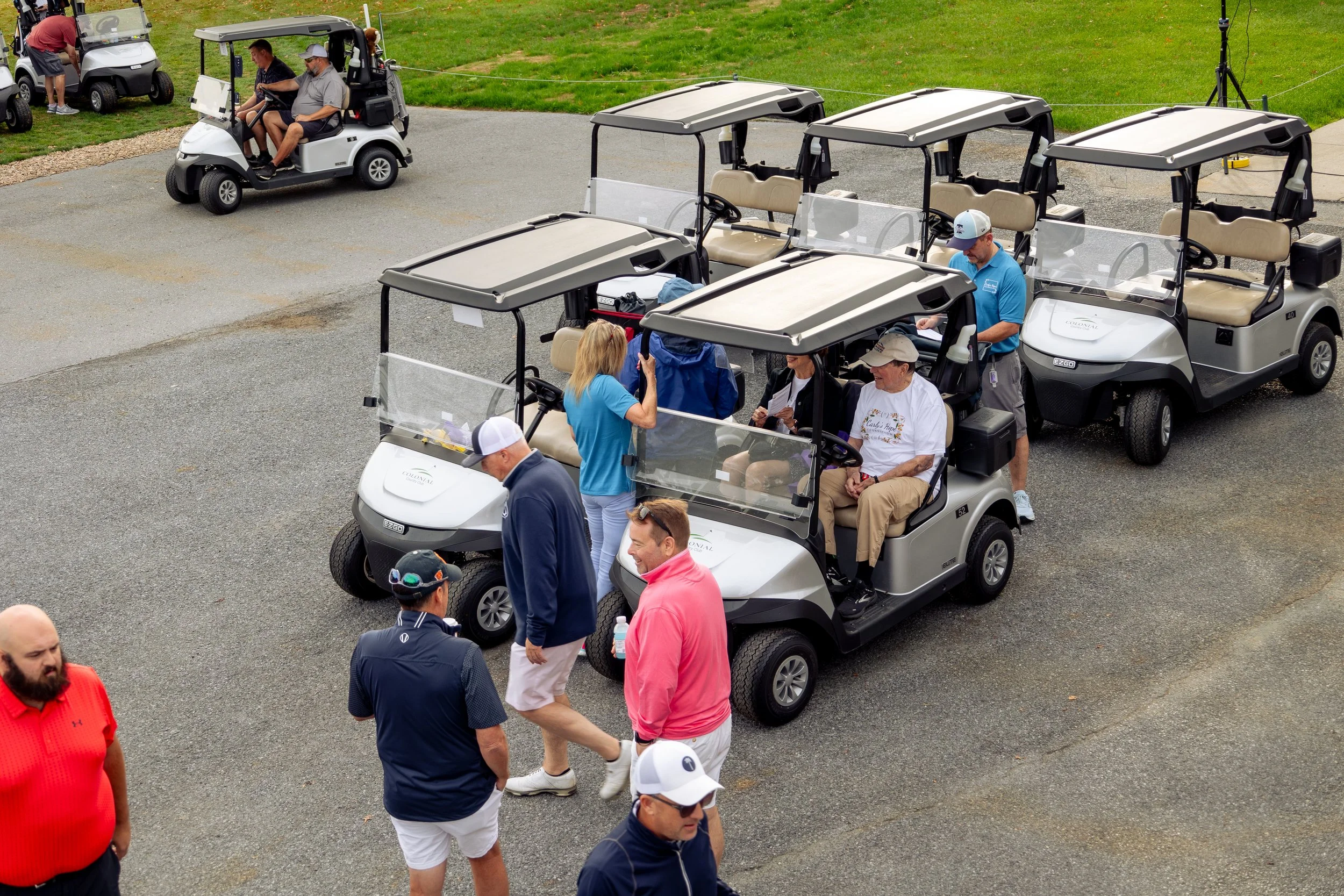 Event photography from a nonprofit golf outing, documenting golfers, course details, group moments, and candid interactions throughout the day in a natural, documentary style.